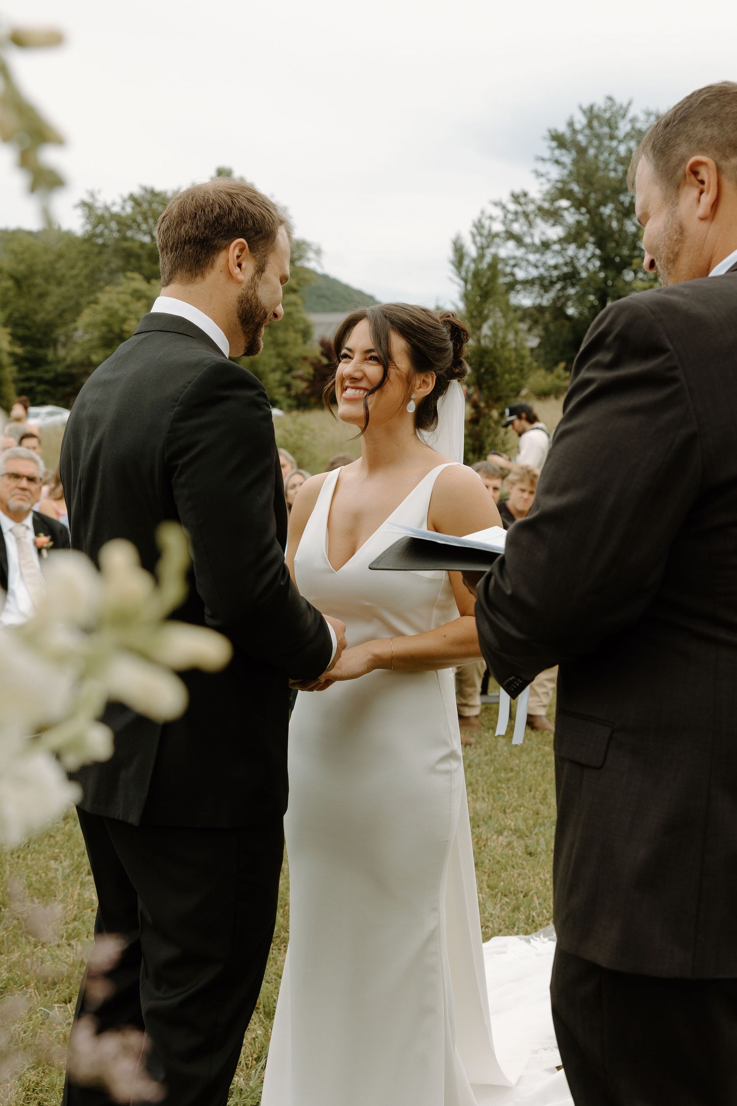 Wedding ceremony candid moments captured outdoors in natural lighting.
