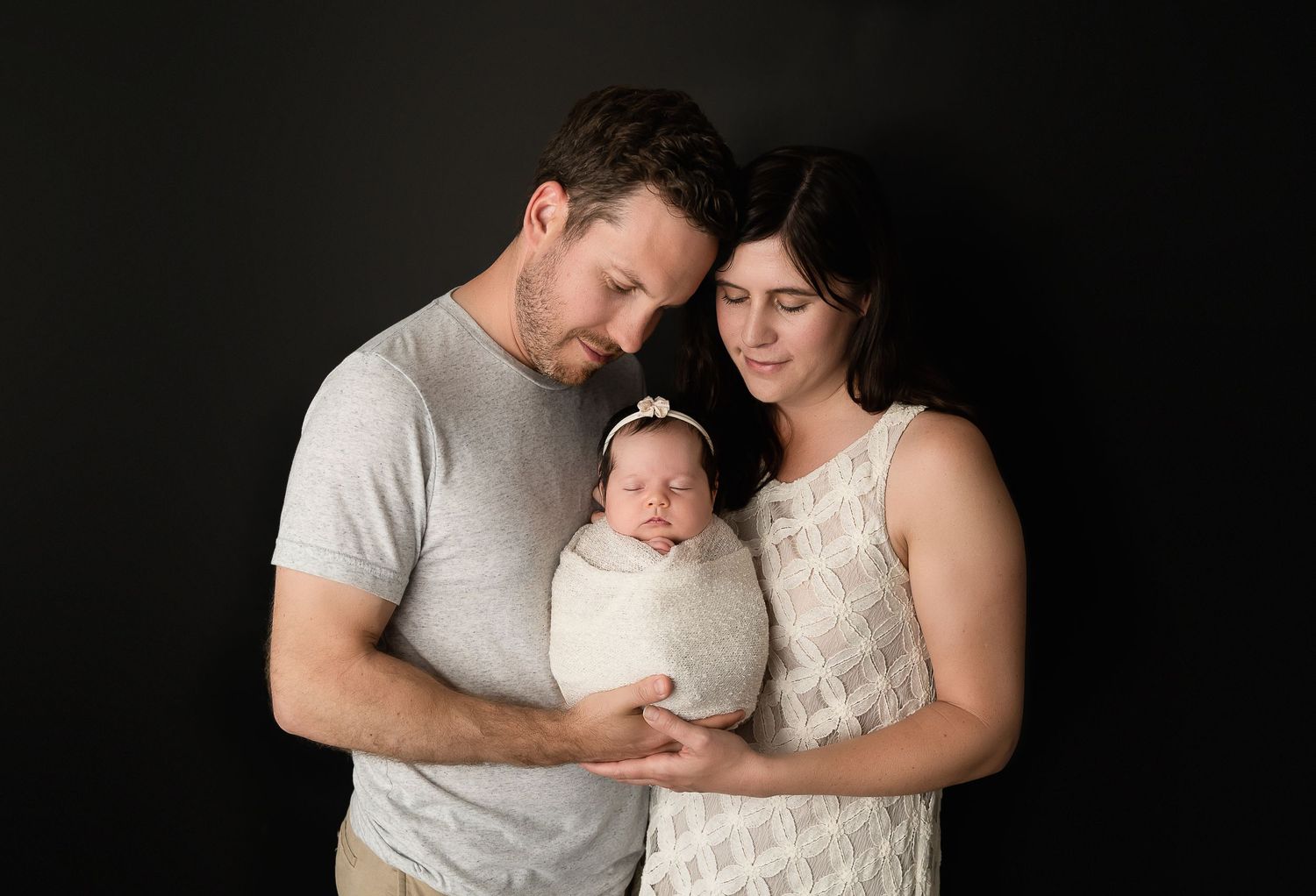 Timeless black and white family portrait with soft lighting and tender moments.