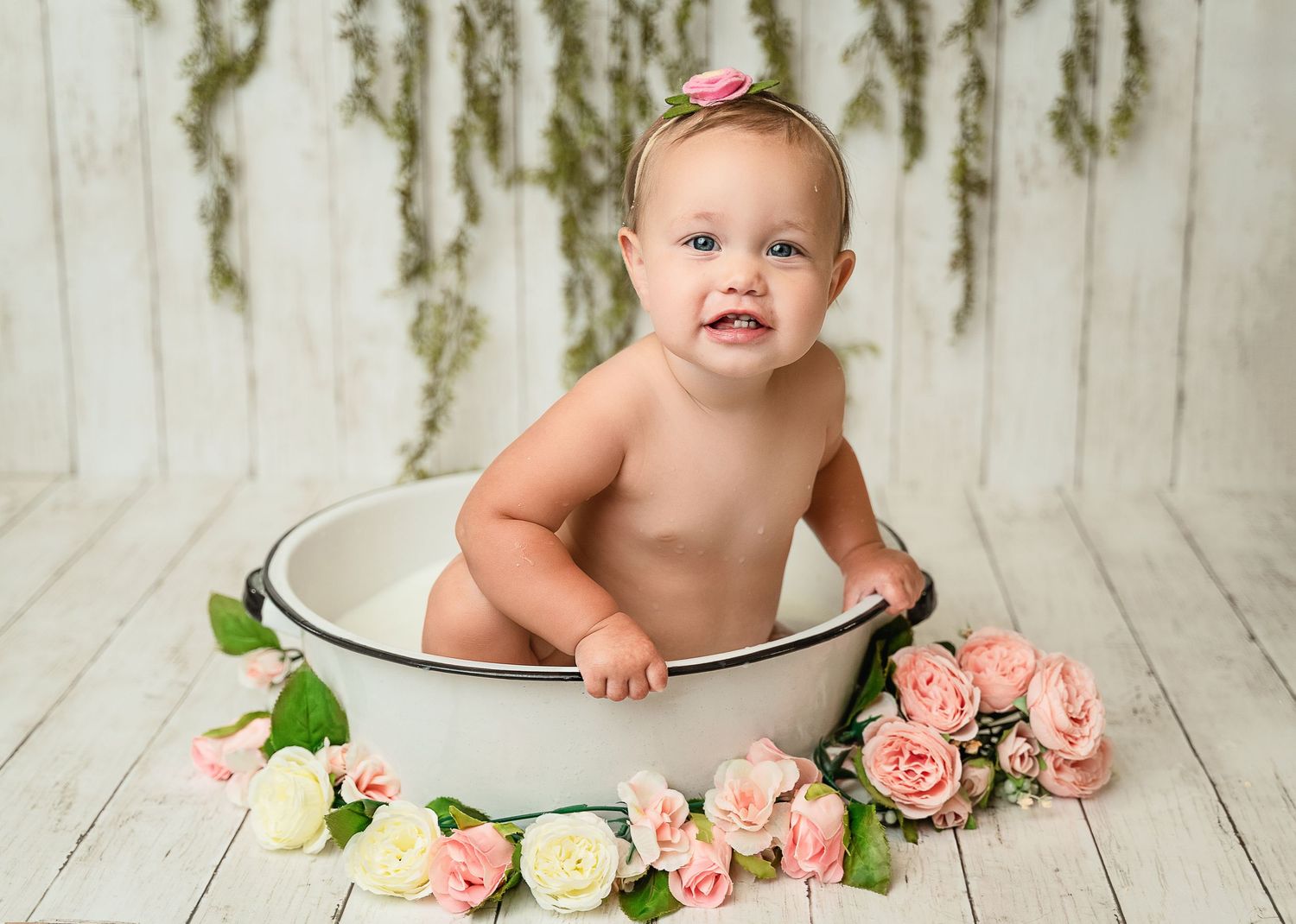 Classic bath basin portrait with pink roses and hanging greenery decorations.