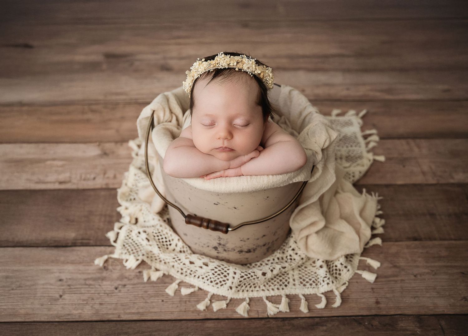 Rustic wooden backdrop newborn photography with vintage lace and flowers.