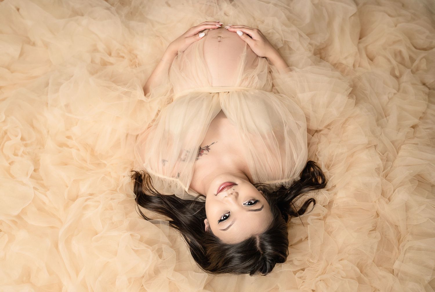 Artistic portrait on cream colored fabric with soft lighting and dreamy mood.