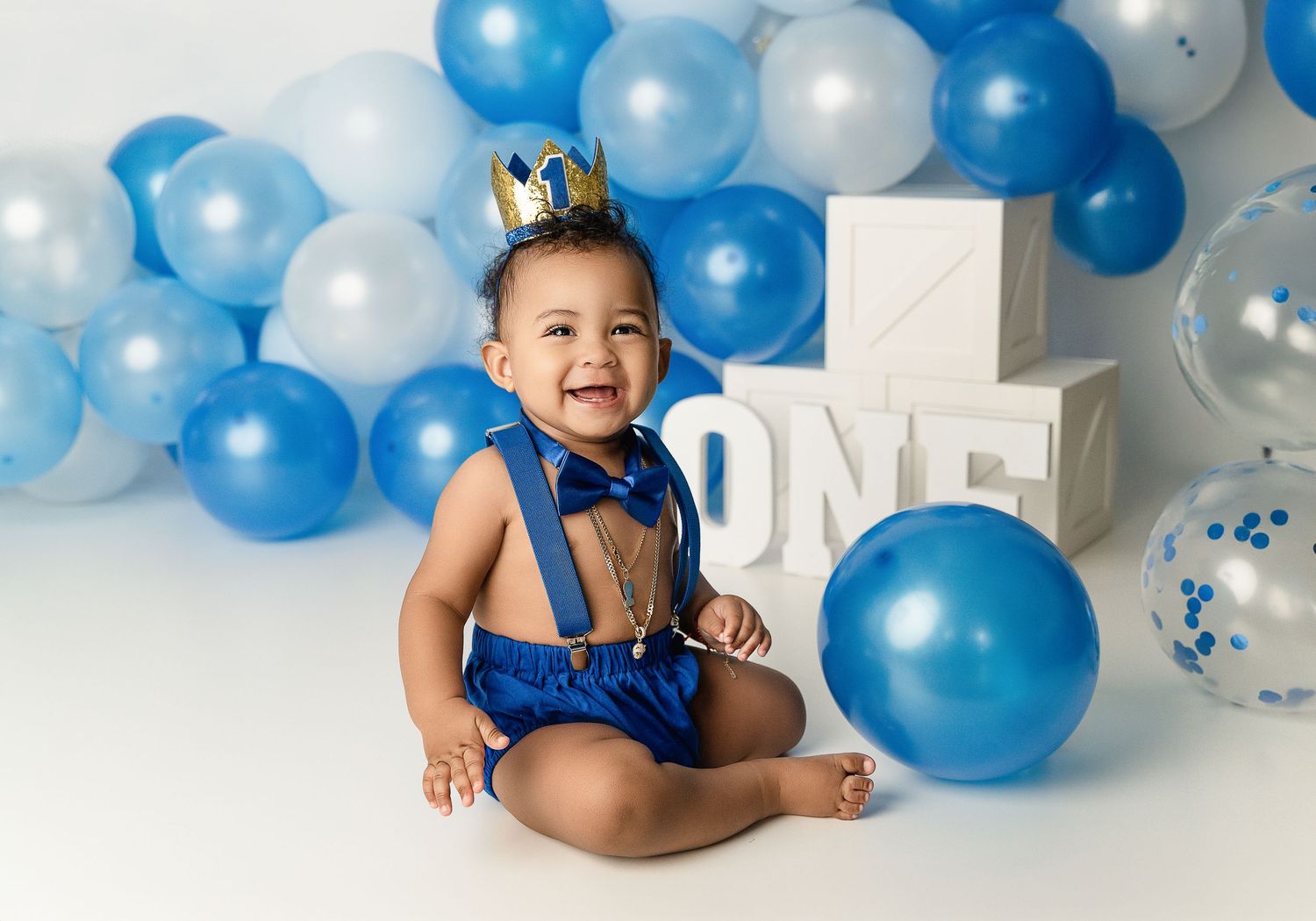 Blue and white balloon display with 'ONE' letters for first birthday celebration.