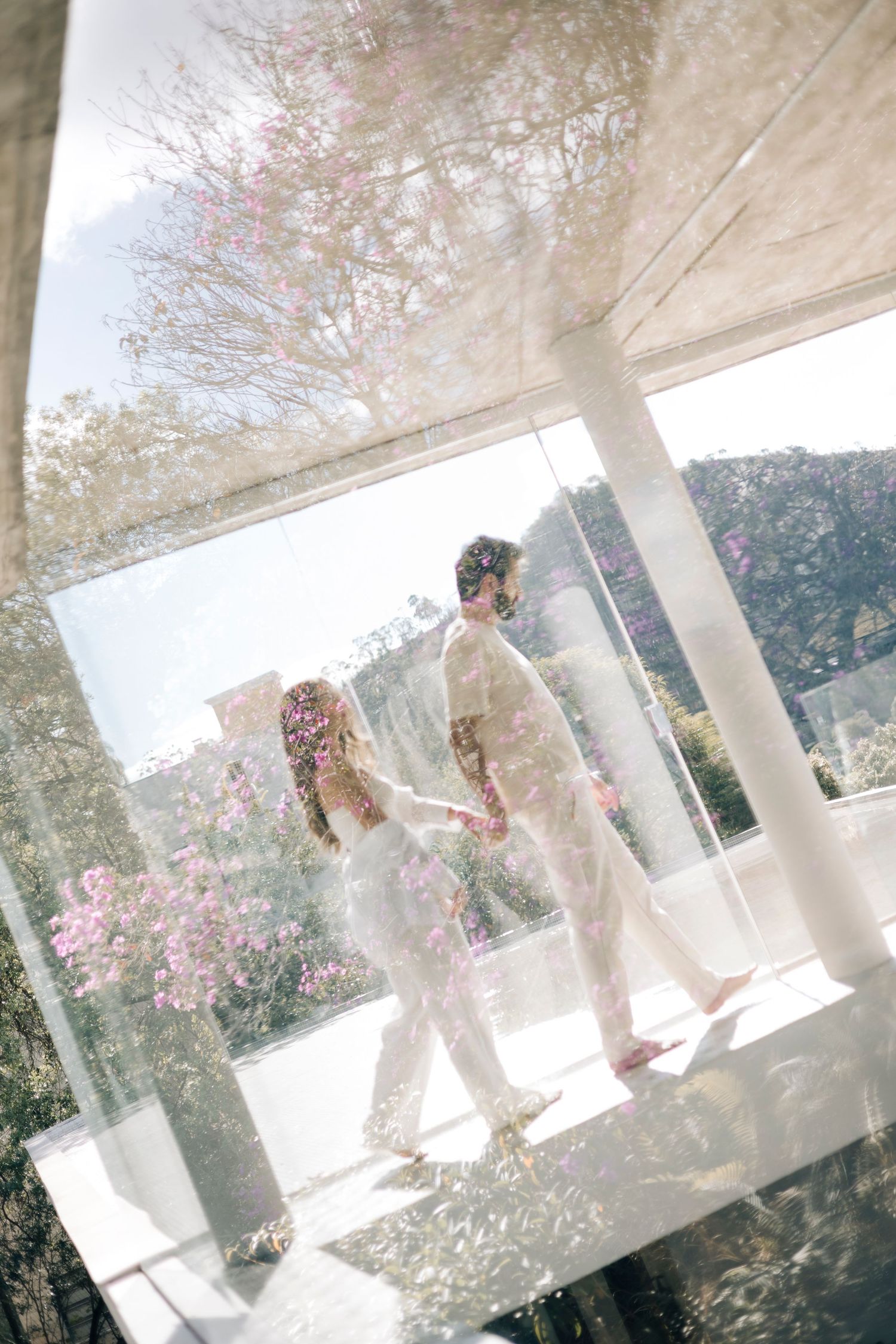 Ethereal sequence of dreamy photos showing white curtains billowing in sunlight with pink flowers visible through the window.
