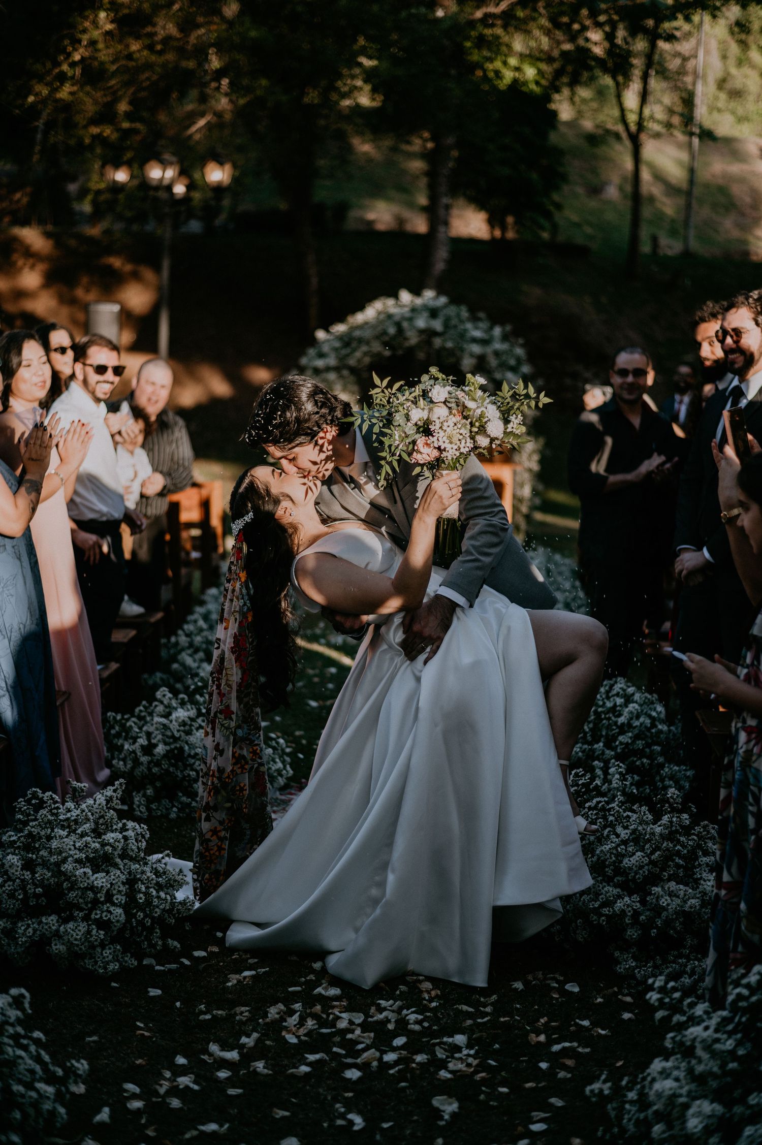 Romantic dance moment at outdoor wedding reception with fairy lights.