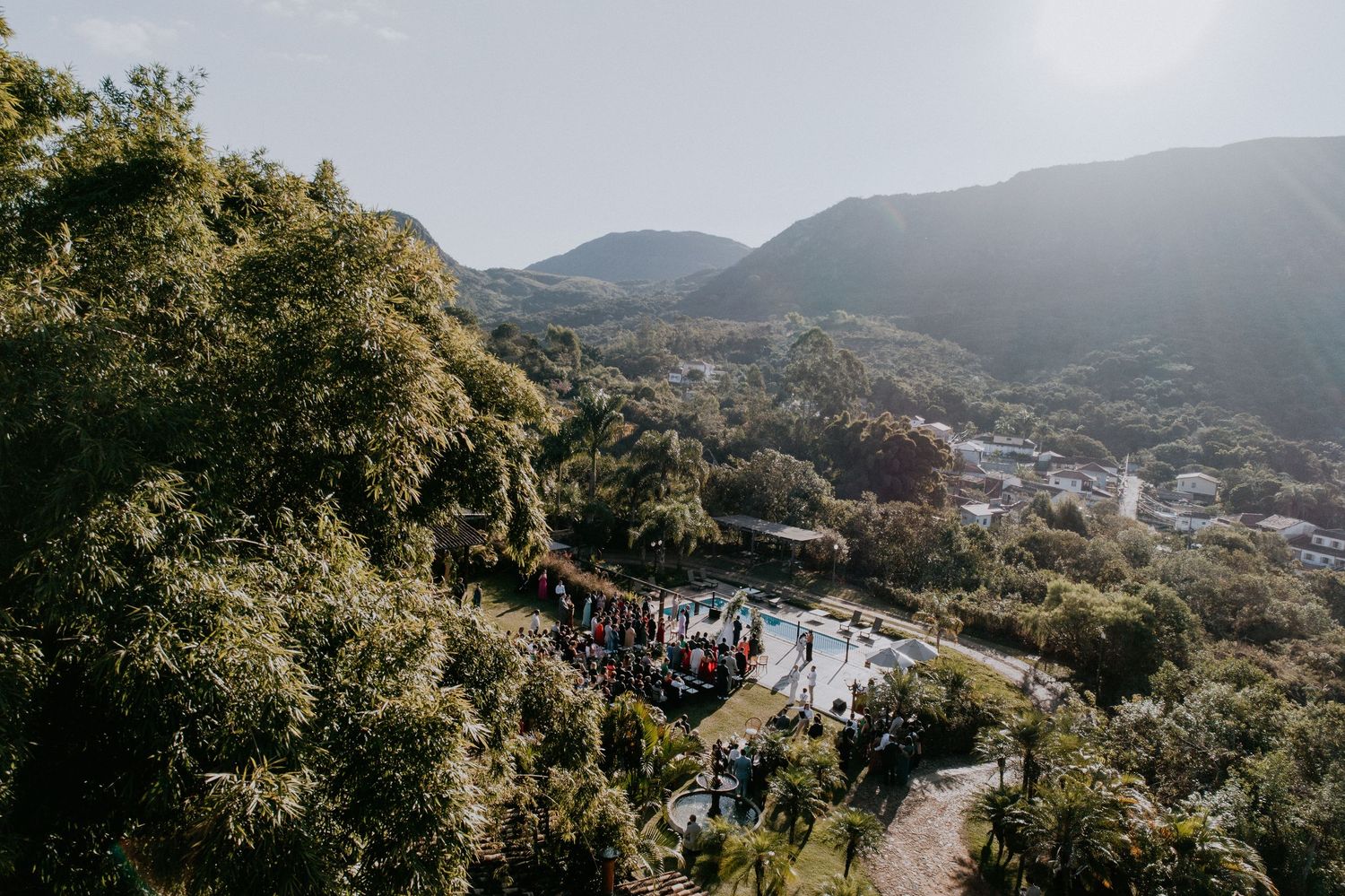 Aerial view of outdoor wedding venue nestled in mountainous landscape.