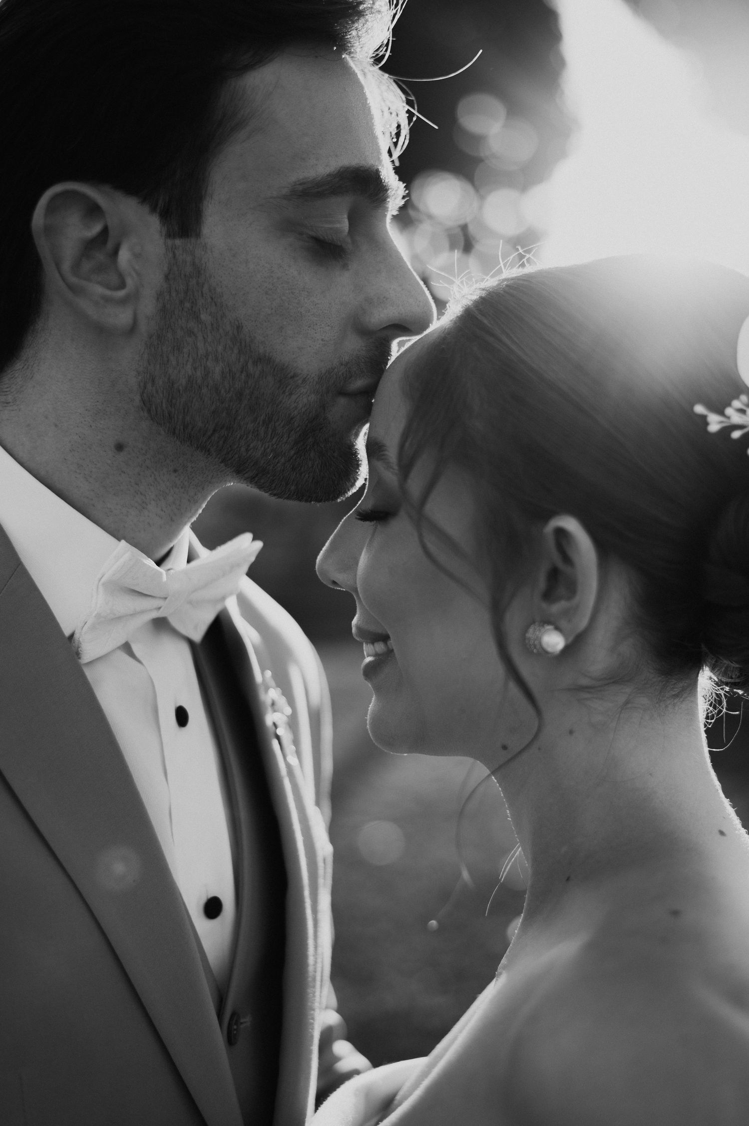 Intimate black and white portrait of newlyweds sharing a romantic moment.