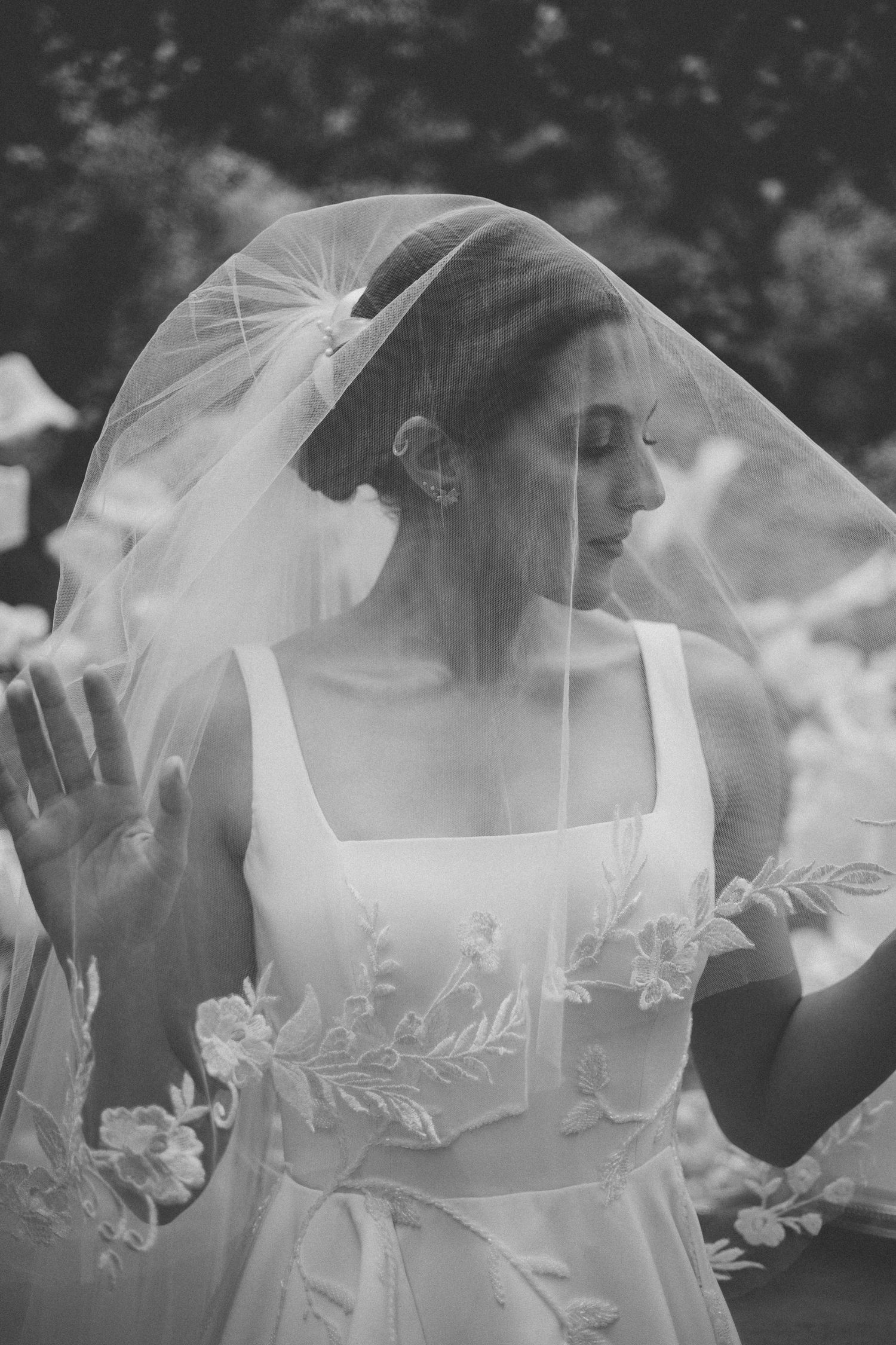 A series of ethereal bridal veil details showing delicate lace patterns and soft tulle in dreamy black and white photography.