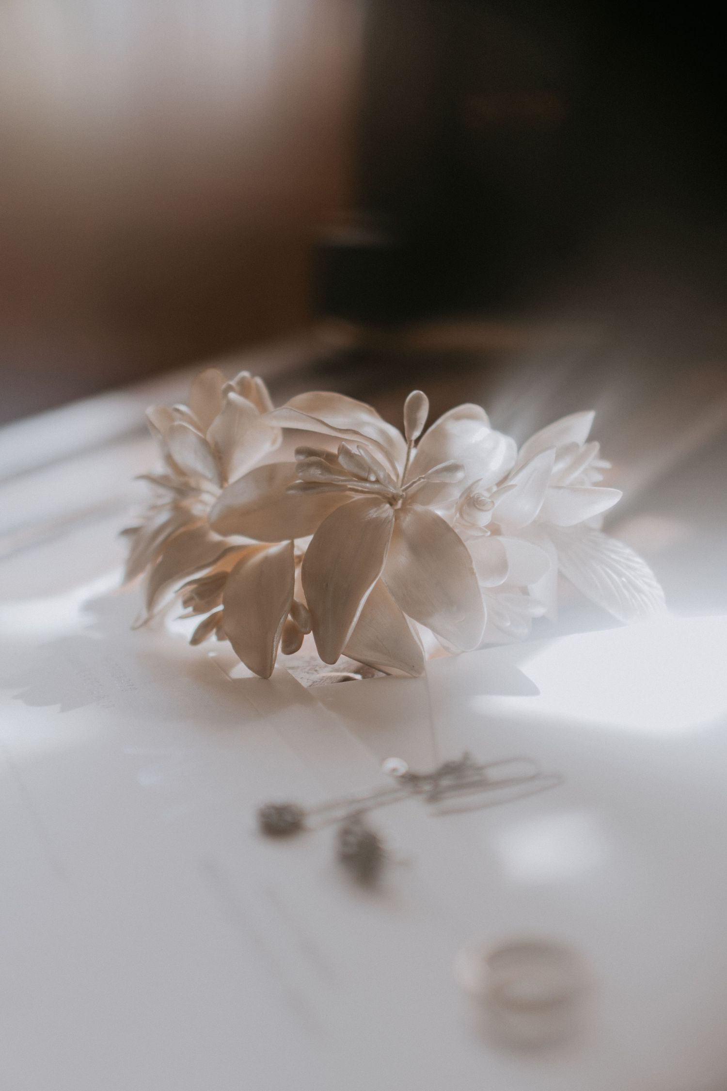 Delicate white paper flower with soft shadows in ethereal lighting.