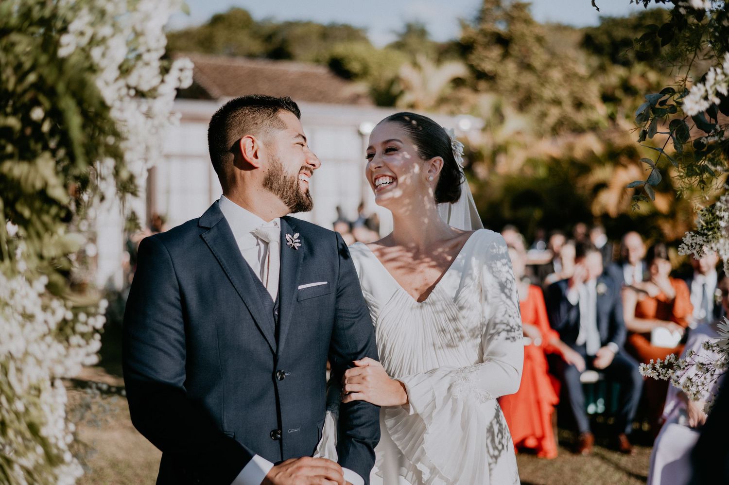 A joyful wedding ceremony moment captured outdoors with guests in attendance.