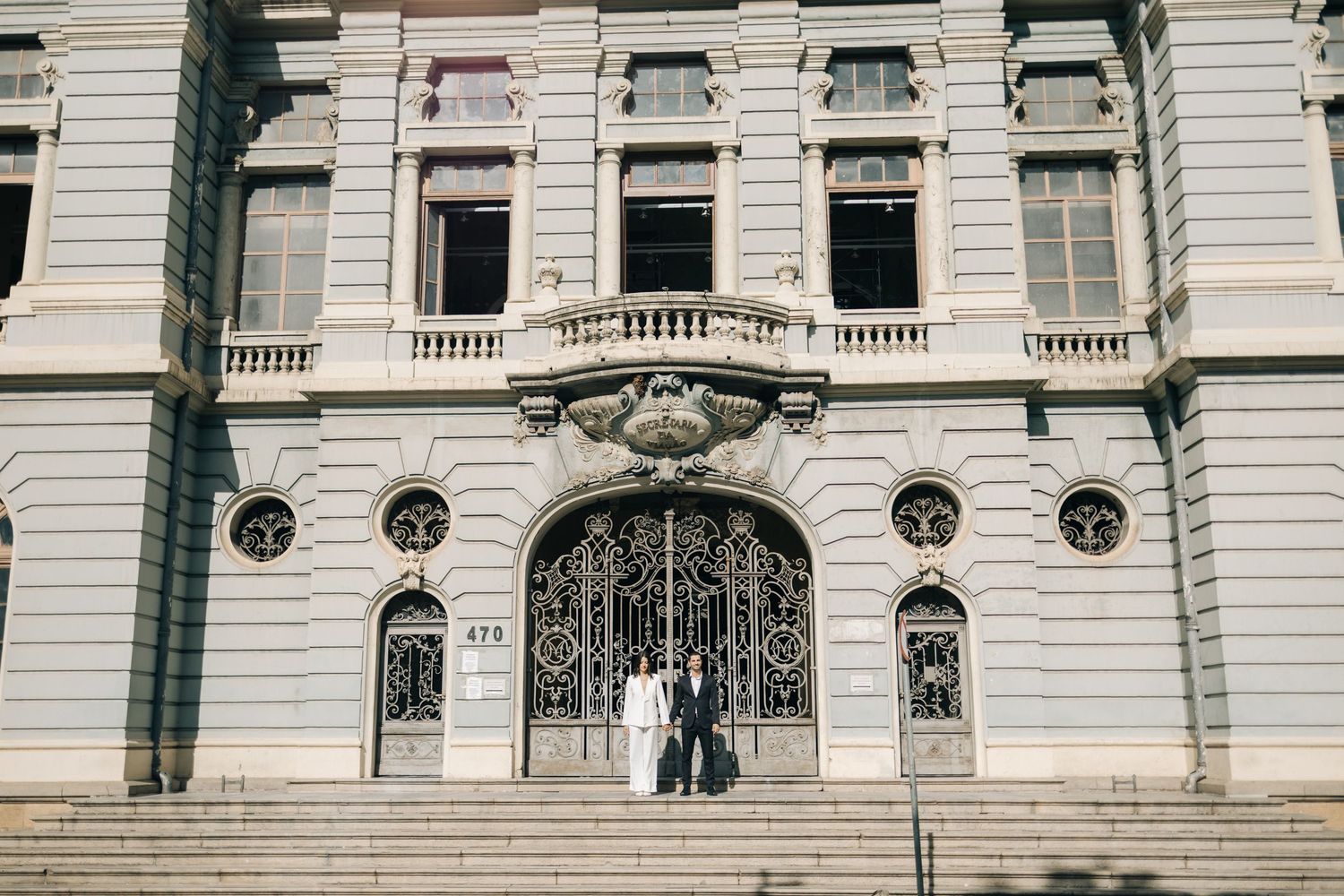 A classic stone government building entrance with ornate columns and architectural details in a grand style.