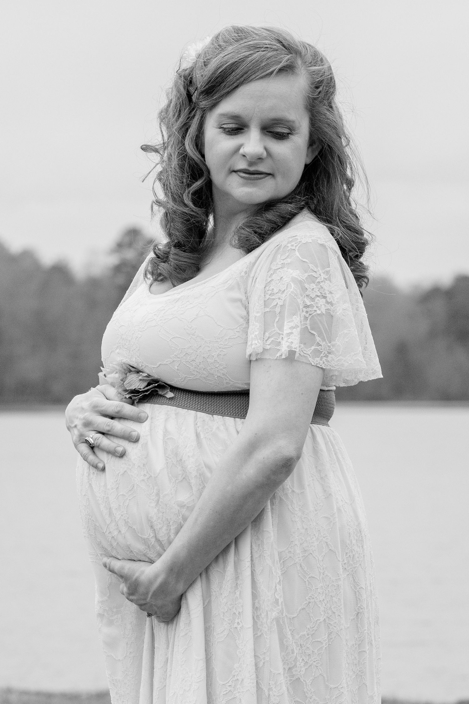 Maternity portrait of expectant mother in lace gown outdoors at sunset — maternity photography in York, SC.