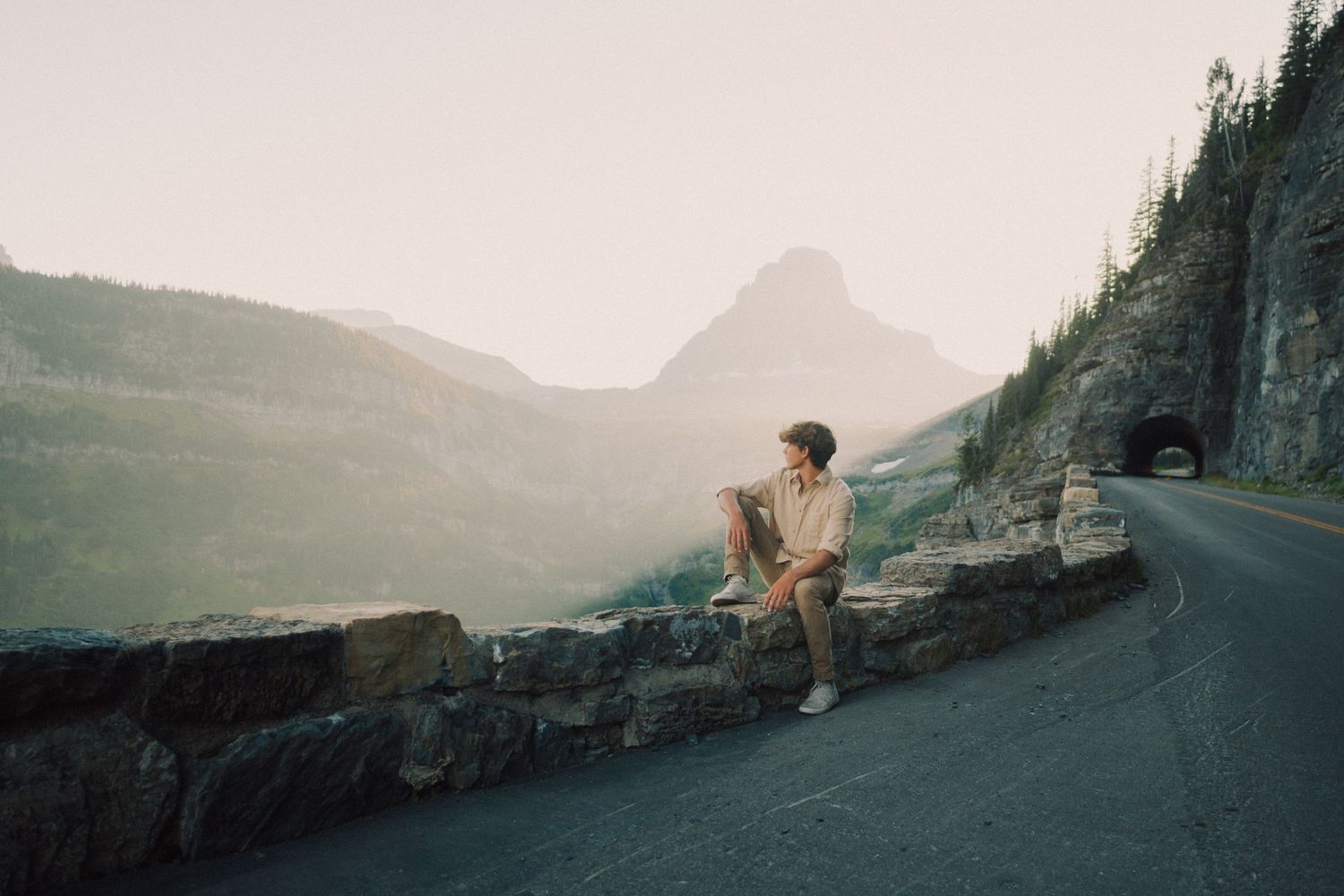 Golden hour portrait of senior in Glacier National Park mountains
