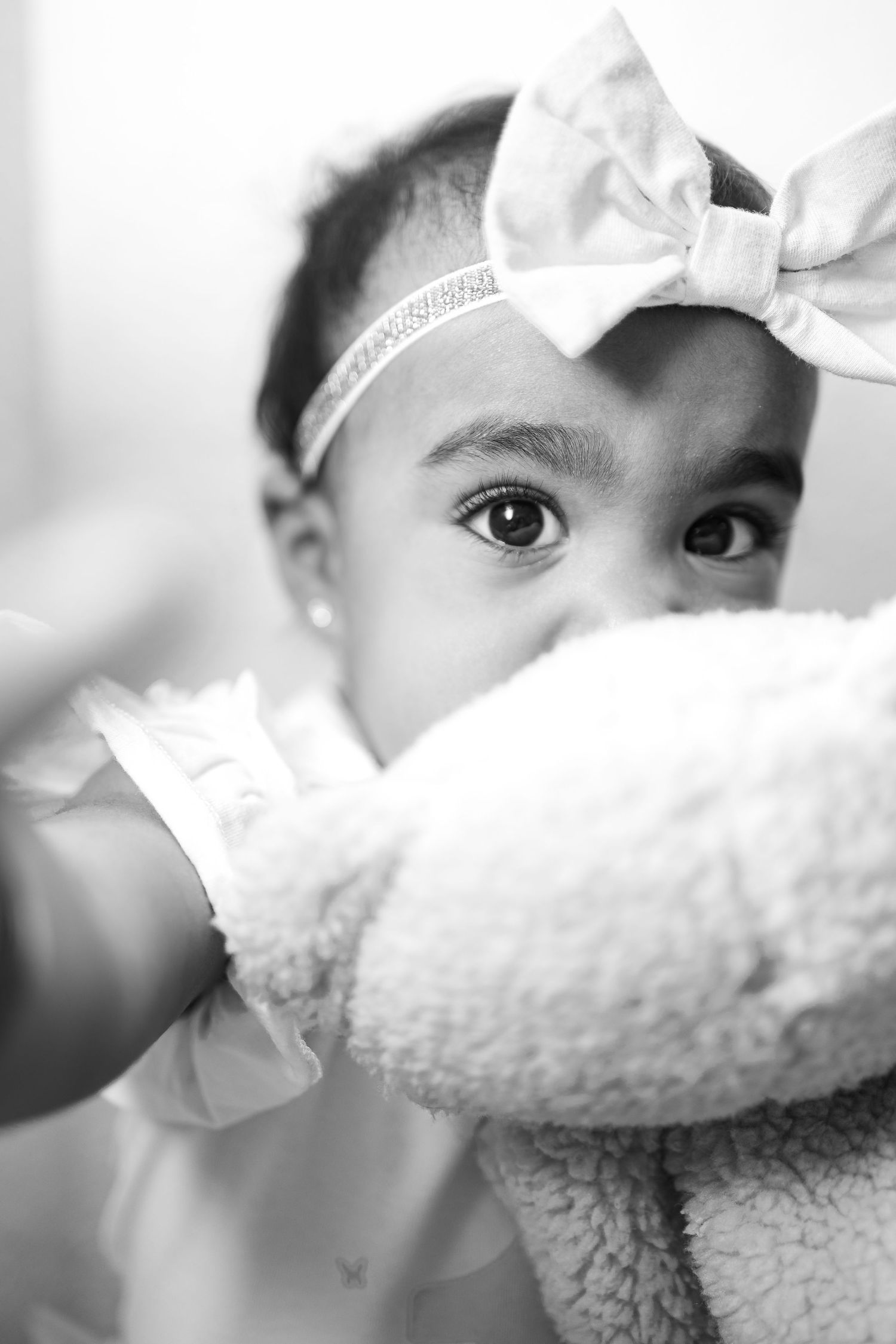A series of black and white close-up shots showing eyes and facial features with white fabric details.
