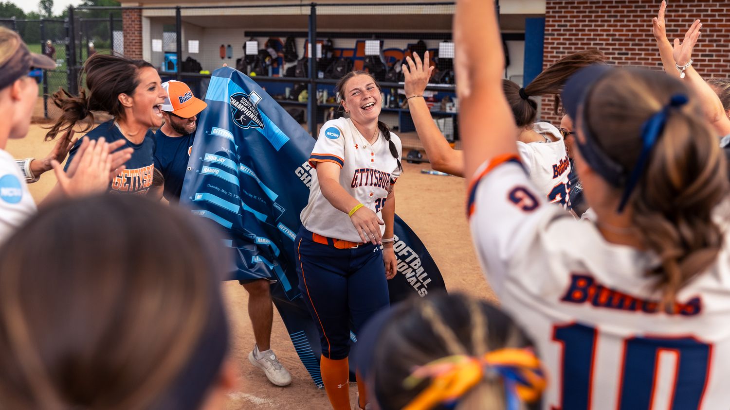 A crowd of excited students cheers and celebrates during a lively sporting event.