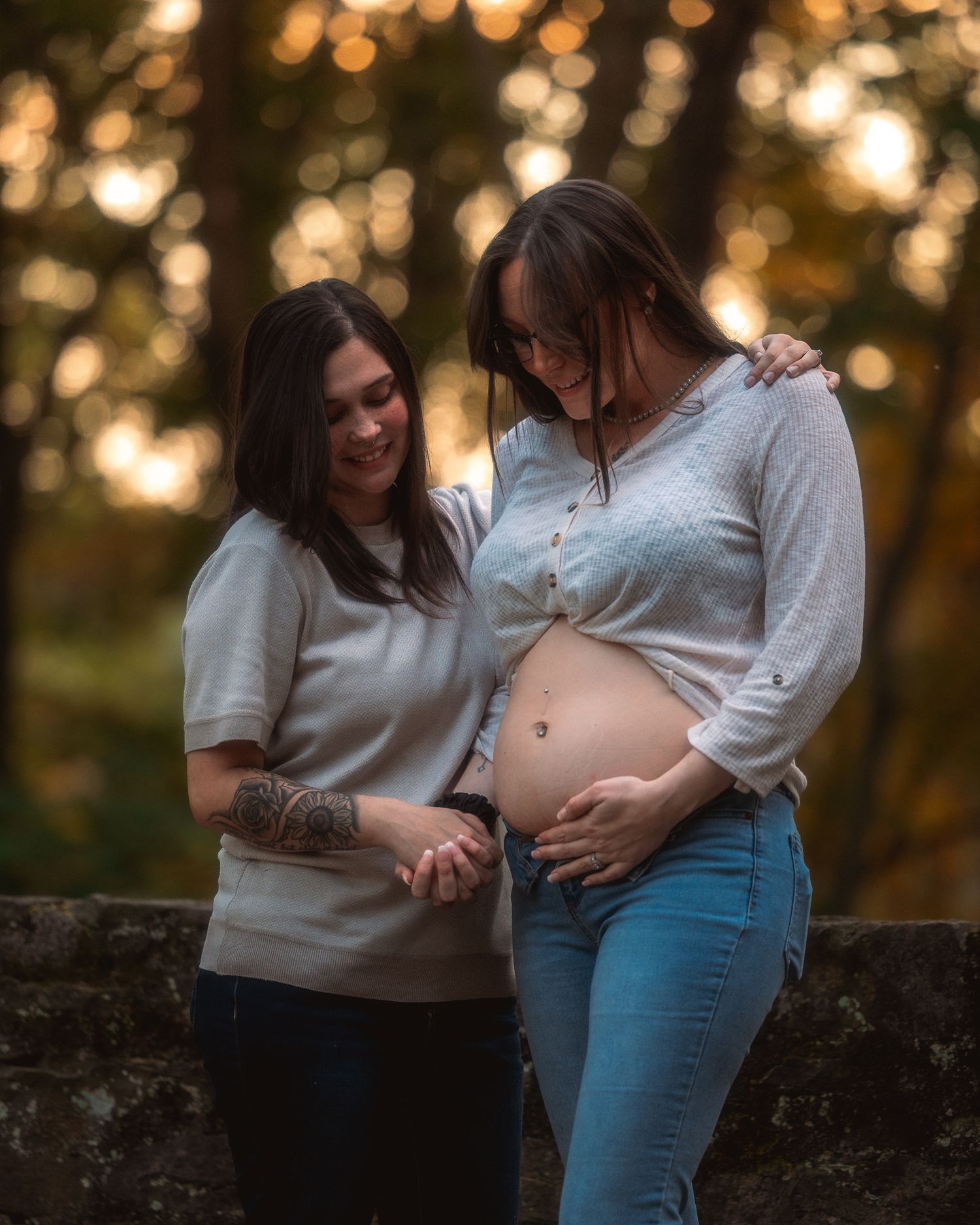A maternity photo session at sunset showing a couple sharing intimate moments against a warm golden backdrop.