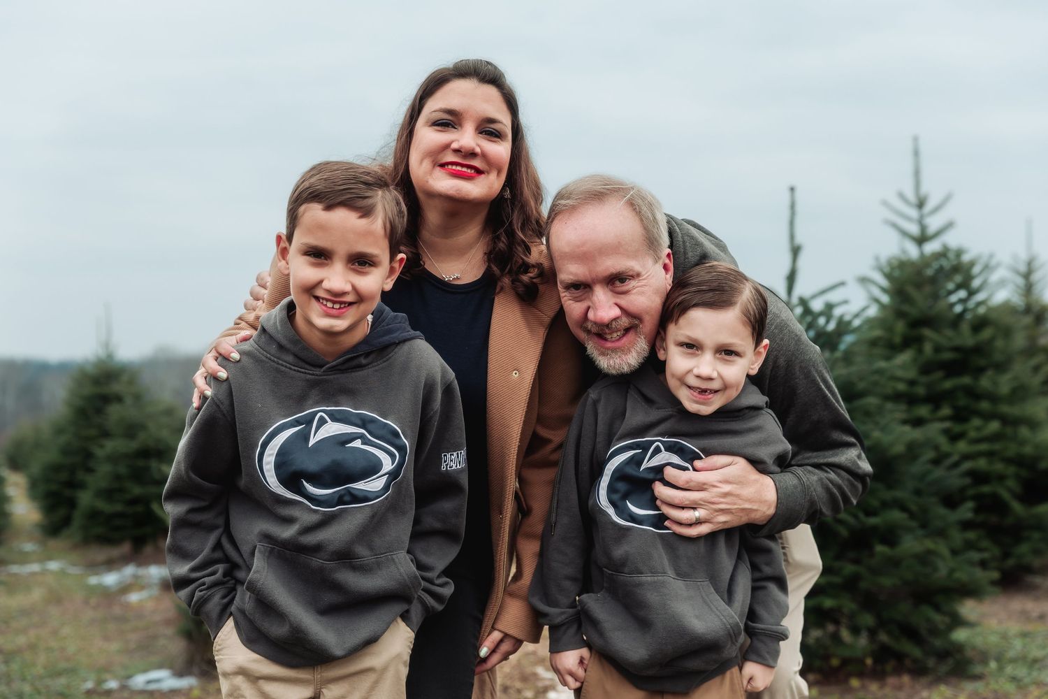 A series of candid family moments captured at a Christmas tree farm during the holiday season.