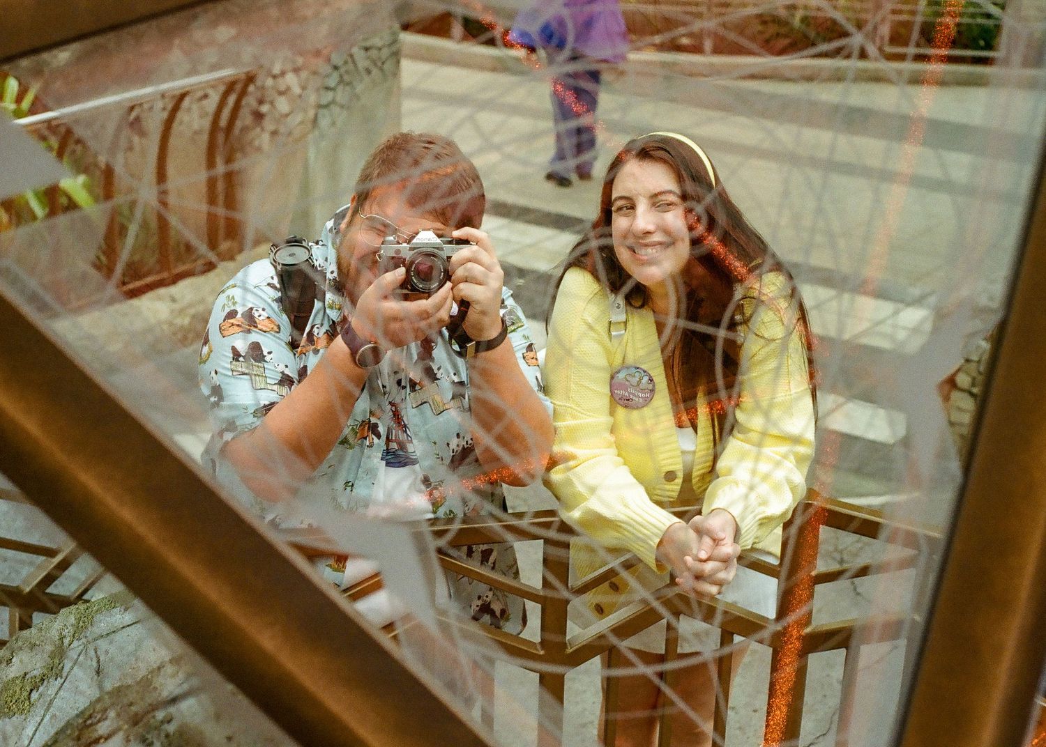 Vintage-style photograph showing people through reflective glass.
