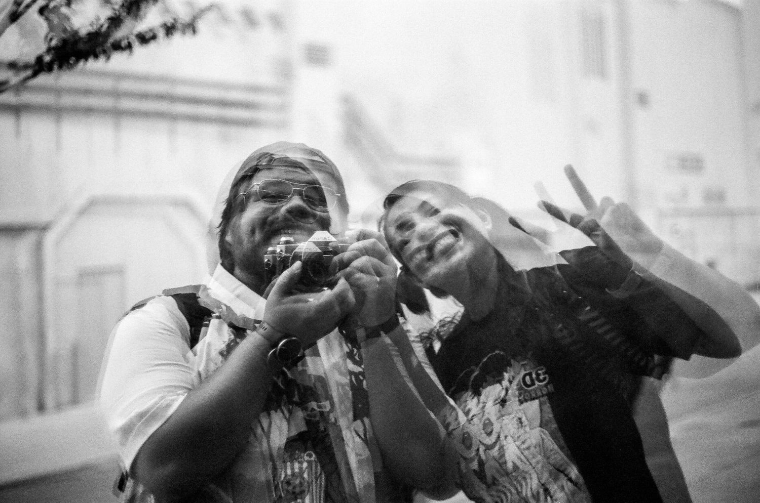 Two friends sharing a joyful moment together in black and white photography.