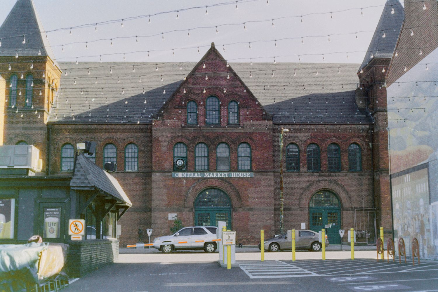 Historic brick train station building with arched windows and multiple entrances shown from different angles in Newport, Vermont.