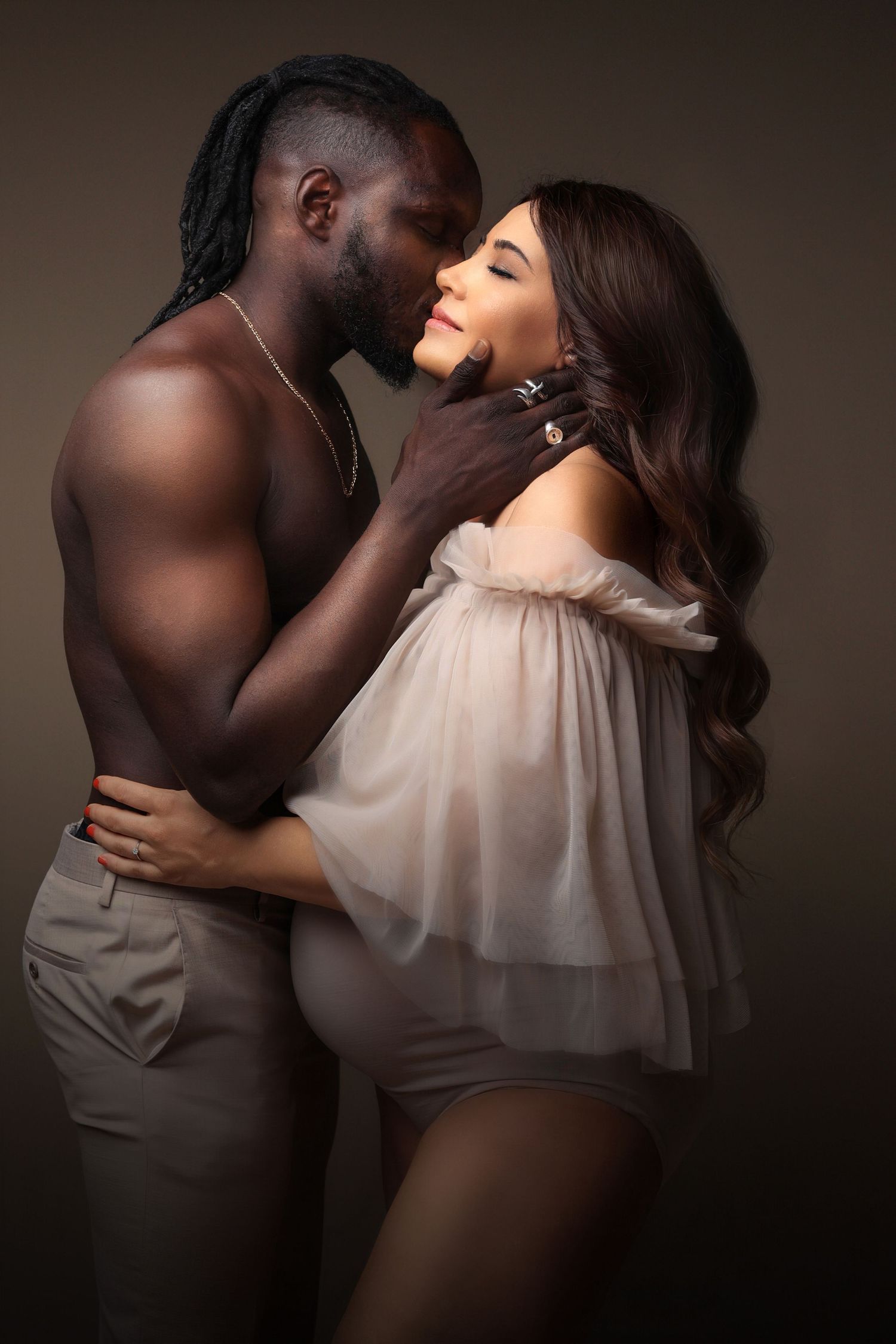 Intimate maternity portrait of couple in soft romantic lighting. Dubai Photographer