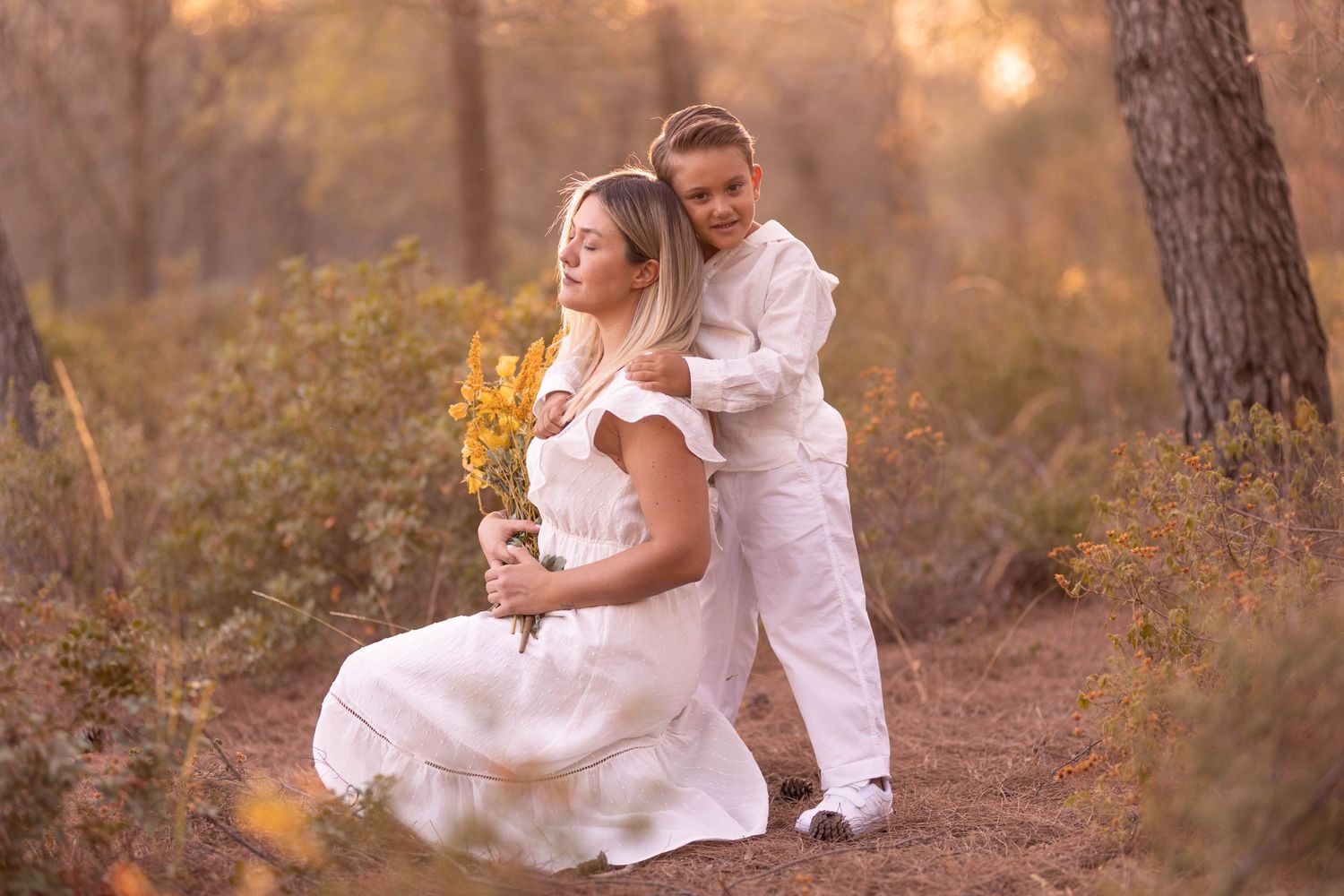 An intimate woodland portrait with sunflowers and white attire in golden evening light. Dubai Photographer