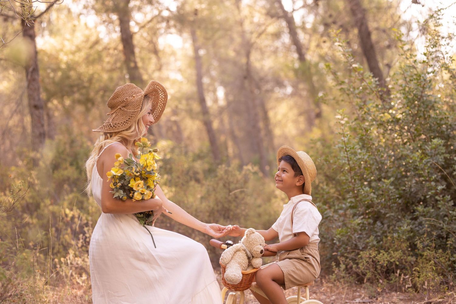 A tender moment captured in a sun-dappled forest setting with yellow flowers and vintage props. Dubai Photographer