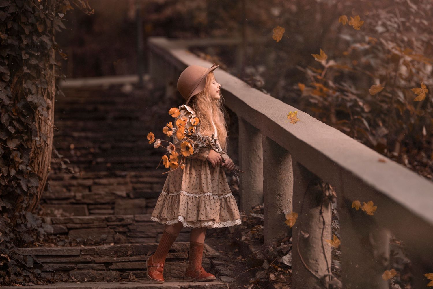 A whimsical autumn scene of a person holding flowers on rustic stone steps. Dubai Photographer