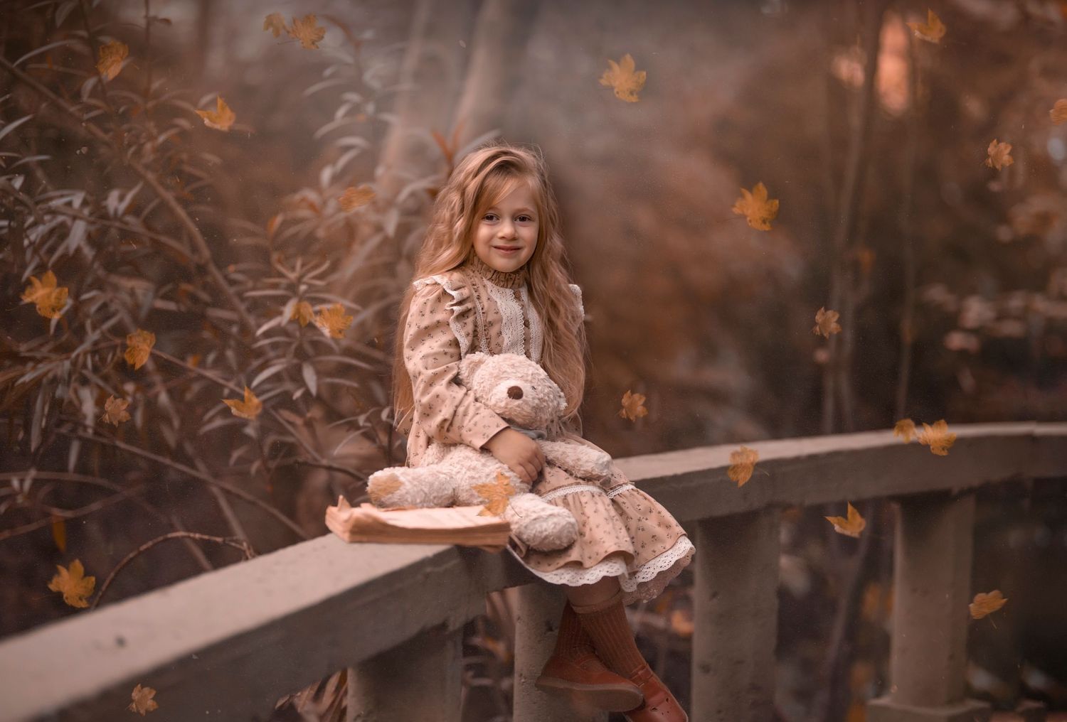 Dreamy autumn portrait of someone in a vintage dress sitting on a rustic railing in warm lighting. Dubai Photographer
