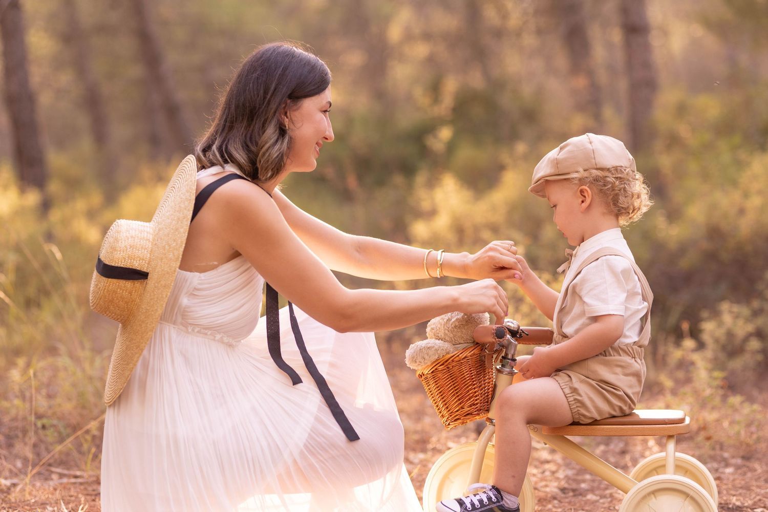 A sweet interaction between figures with a basket in a glowing forest setting. Dubai Photographer