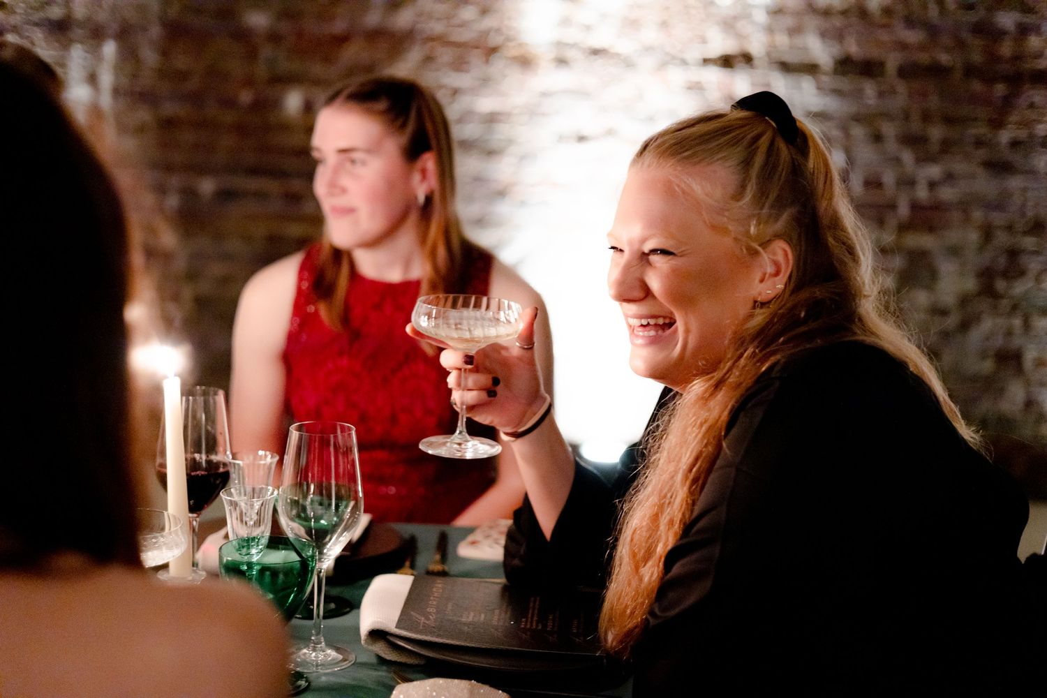 Guests enjoying conversation at an intimate dinner party.