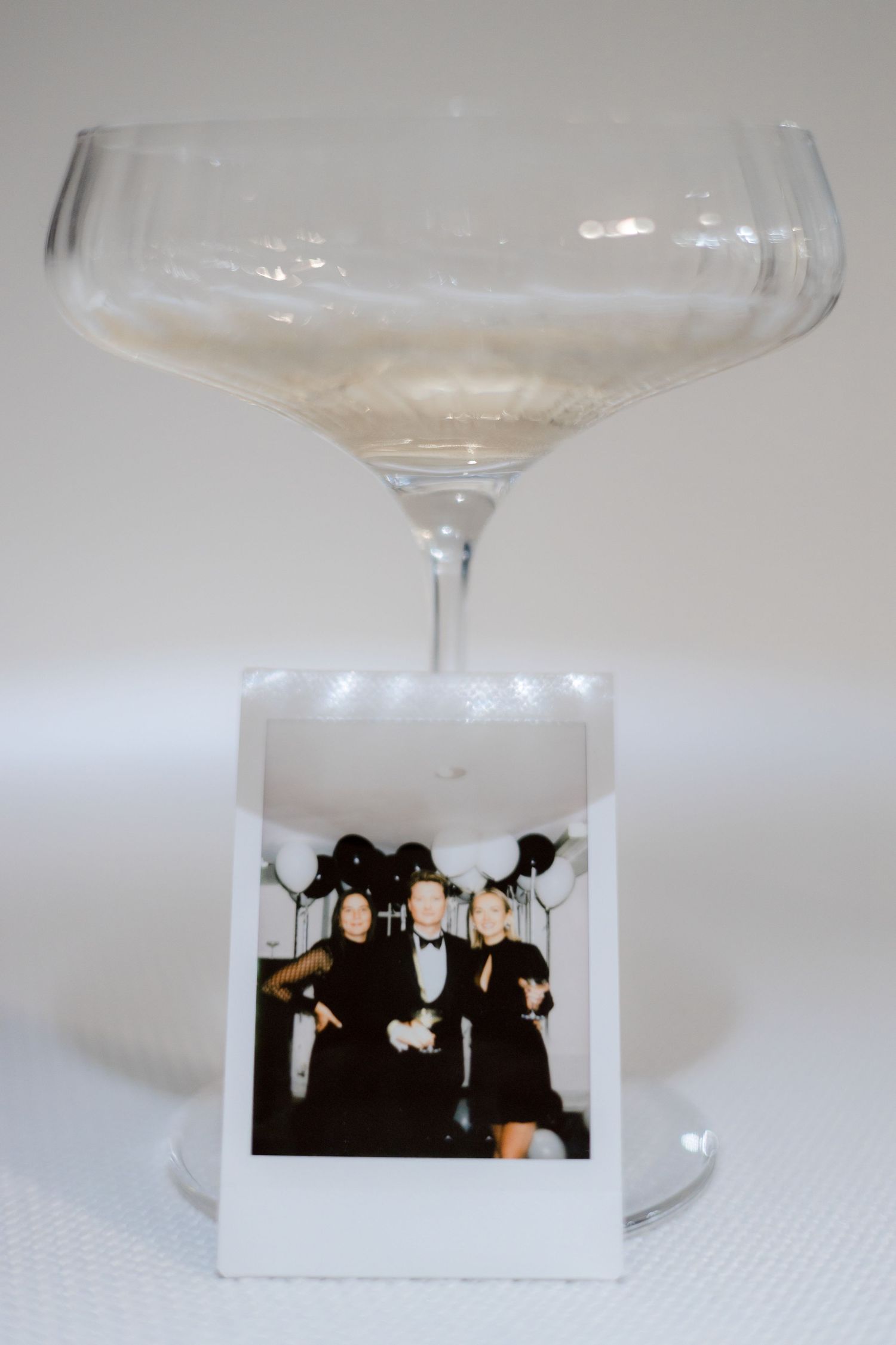 Decorative champagne glass with a small photograph displayed in its base.