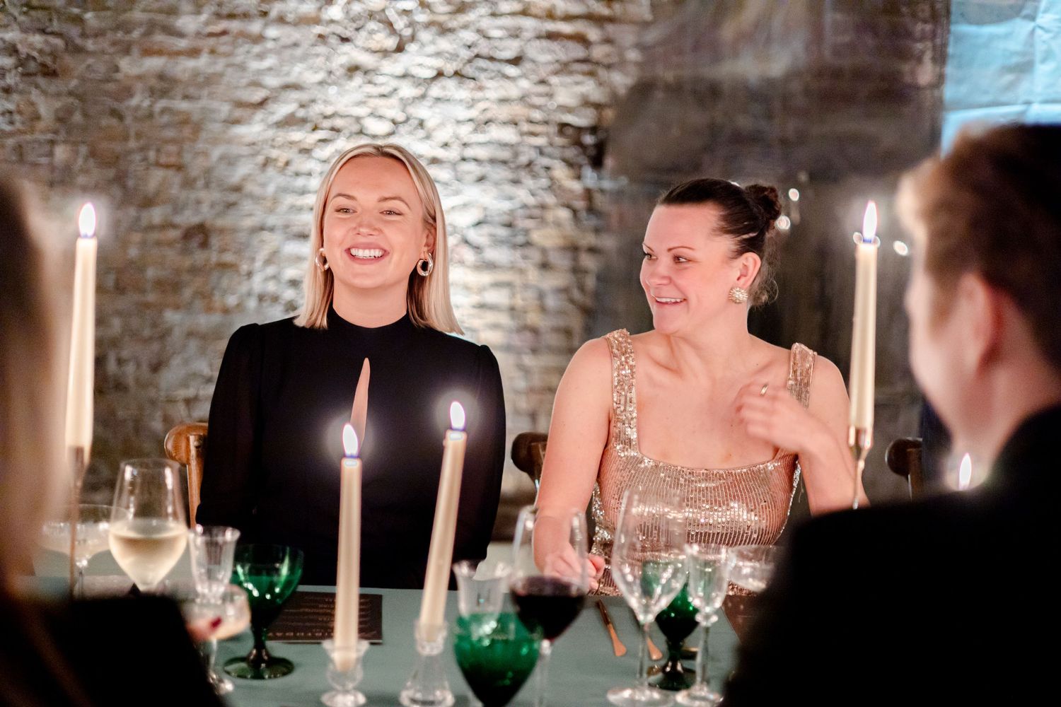 Guests sharing laughter during an elegant evening celebration.