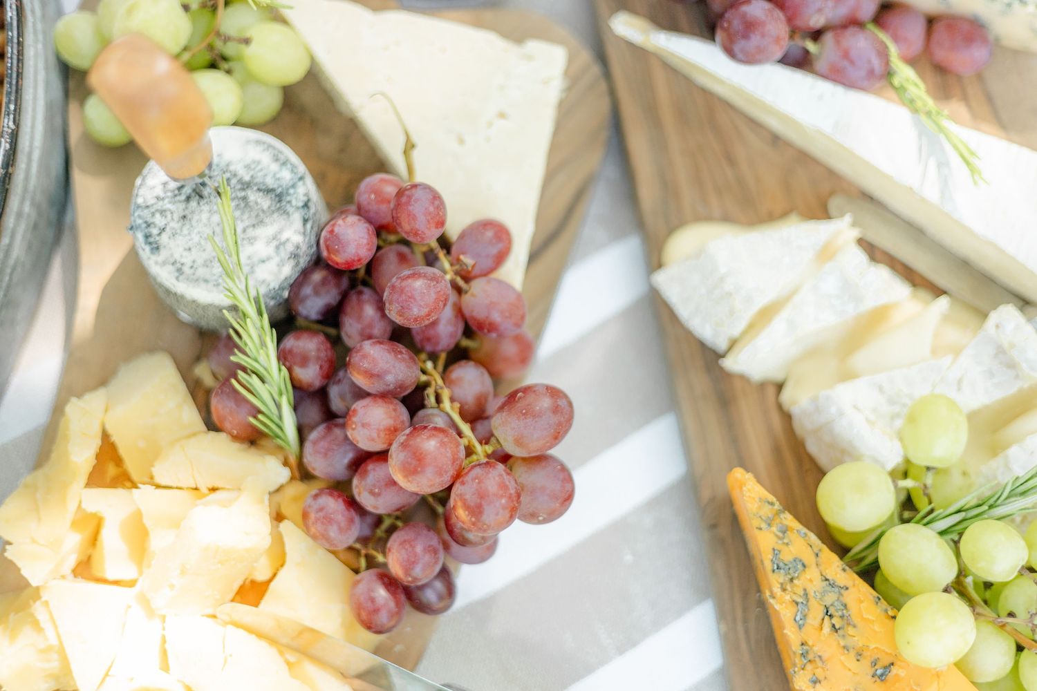 Elegant cheese board featuring grapes, brie, and various cheese varieties.
