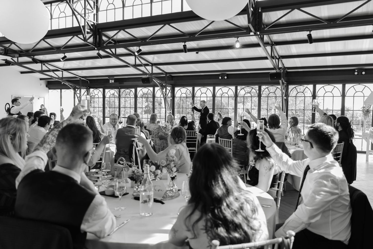 Wedding ceremony setup in a rustic timber barn with exposed beams.