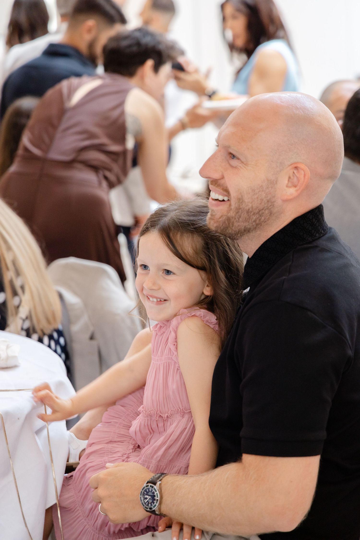 A heartwarming moment between a parent and child at a formal gathering.