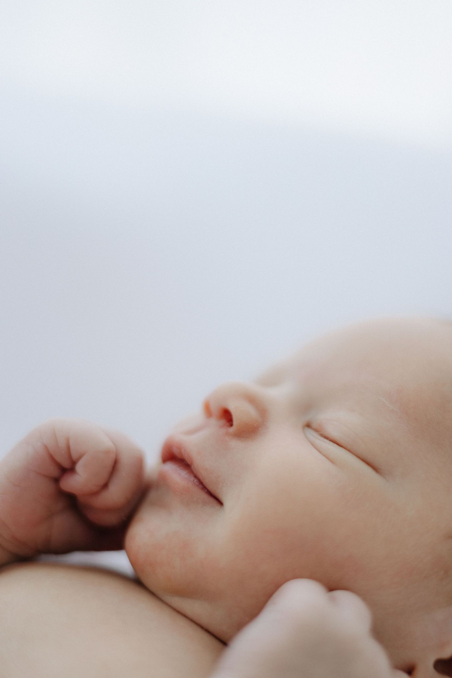 Artistic macro photography series of sleeping newborn details.