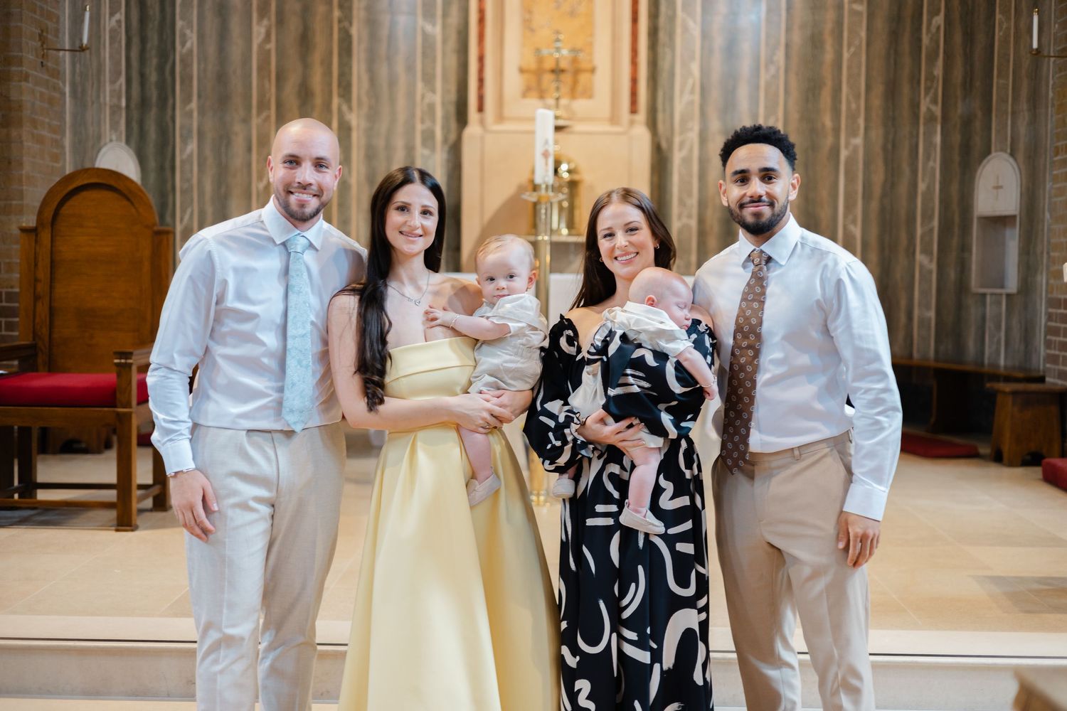 Family group photo in a church interior with elegant architectural details.