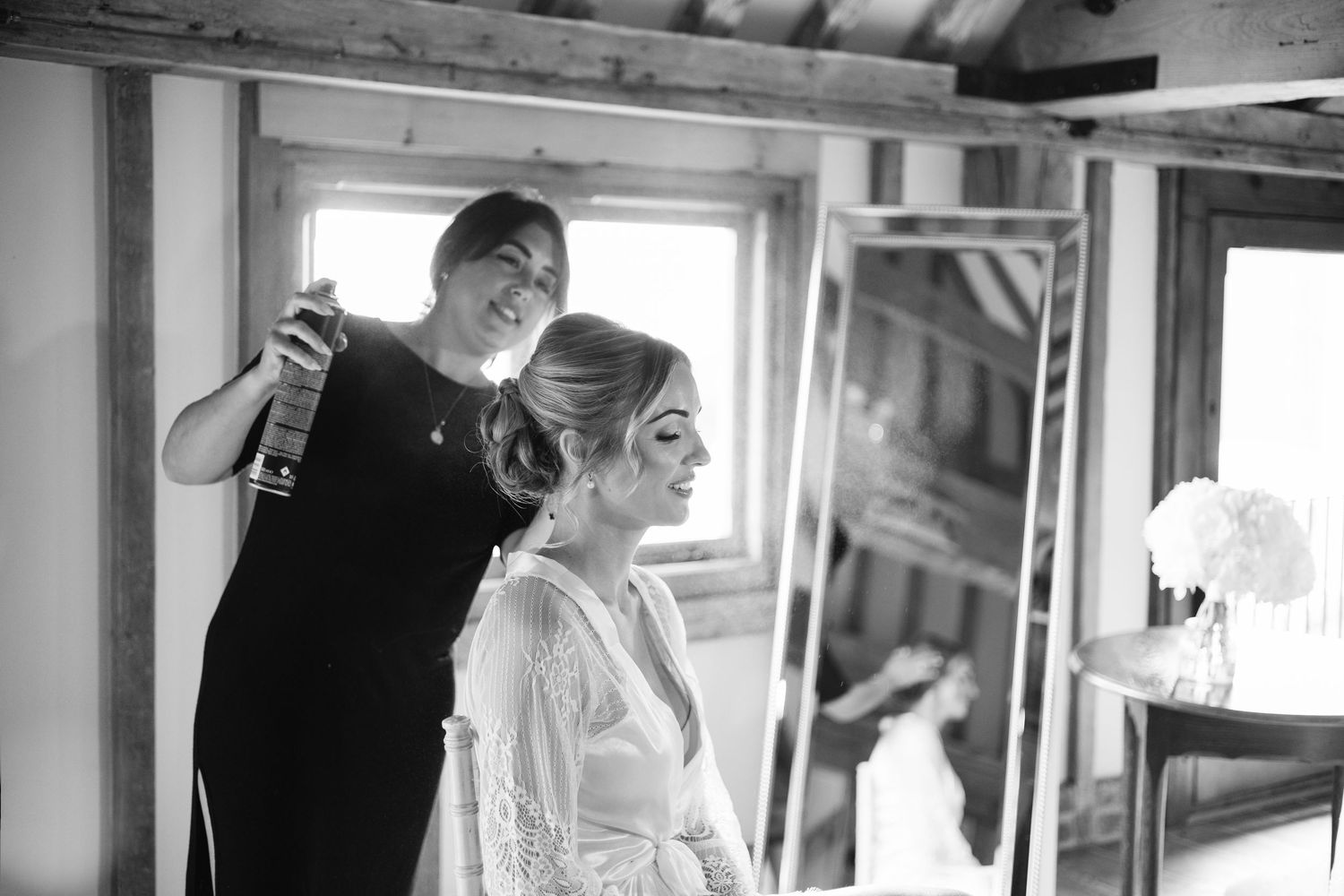 Interior wedding preparation moments captured in dramatic black and white photography.