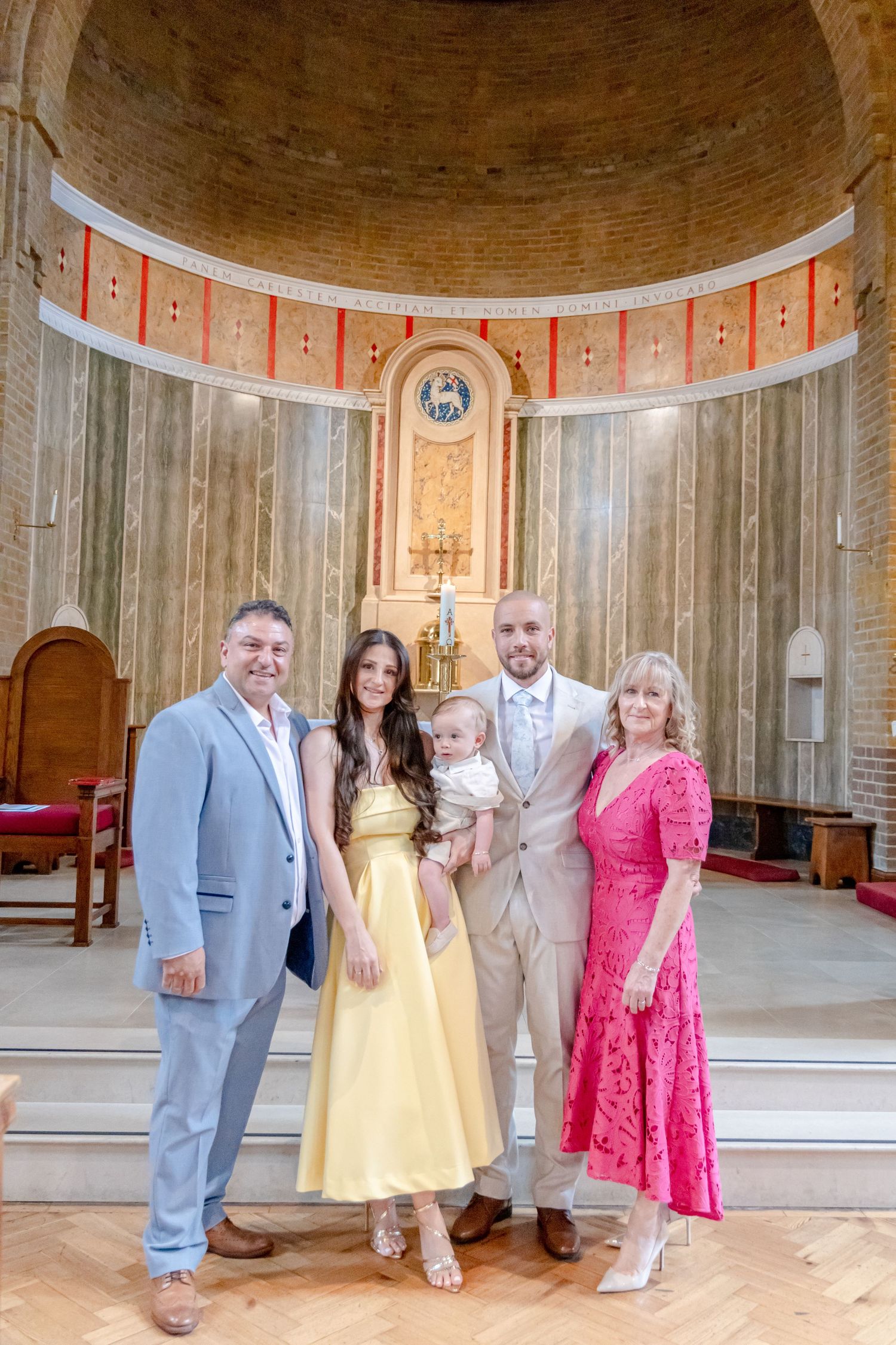 Family gathering in an ornate circular room with peach-colored walls and architectural details.