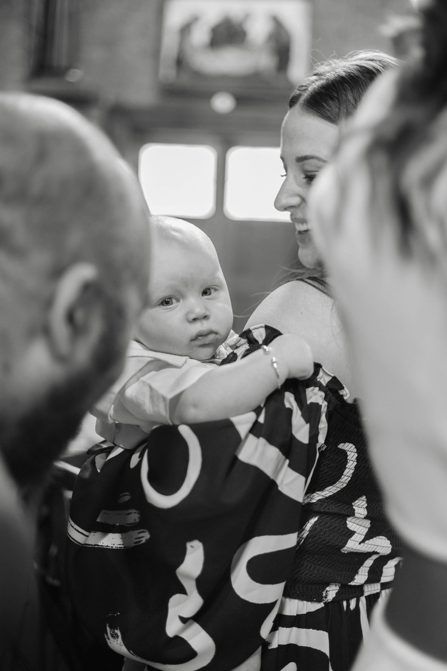 Black and white candid moment captured during a formal gathering.