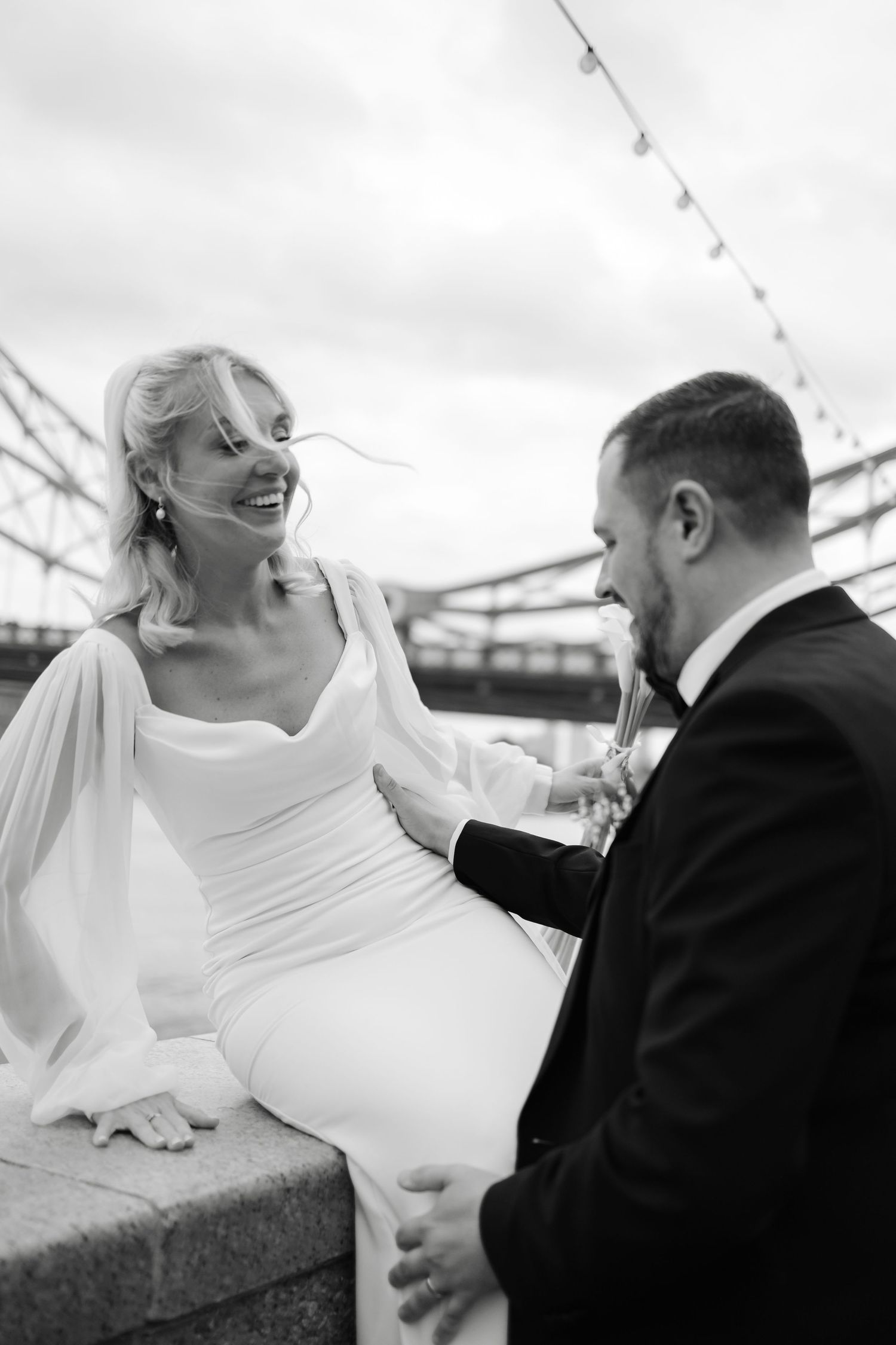 Candid moments between couple during wedding photoshoot near Tower Bridge.