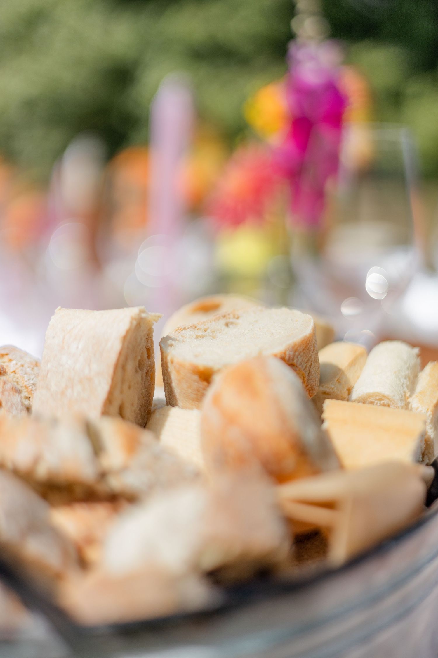 Close-up of artfully plated appetizers on serving platters at an outdoor event.