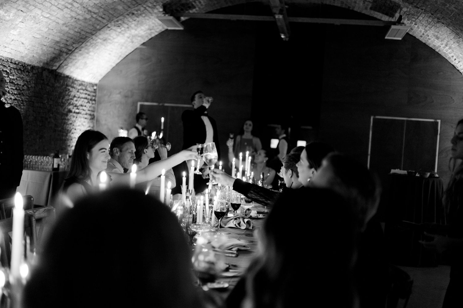 Dramatic low-light architectural shot of an arched ceiling venue space.