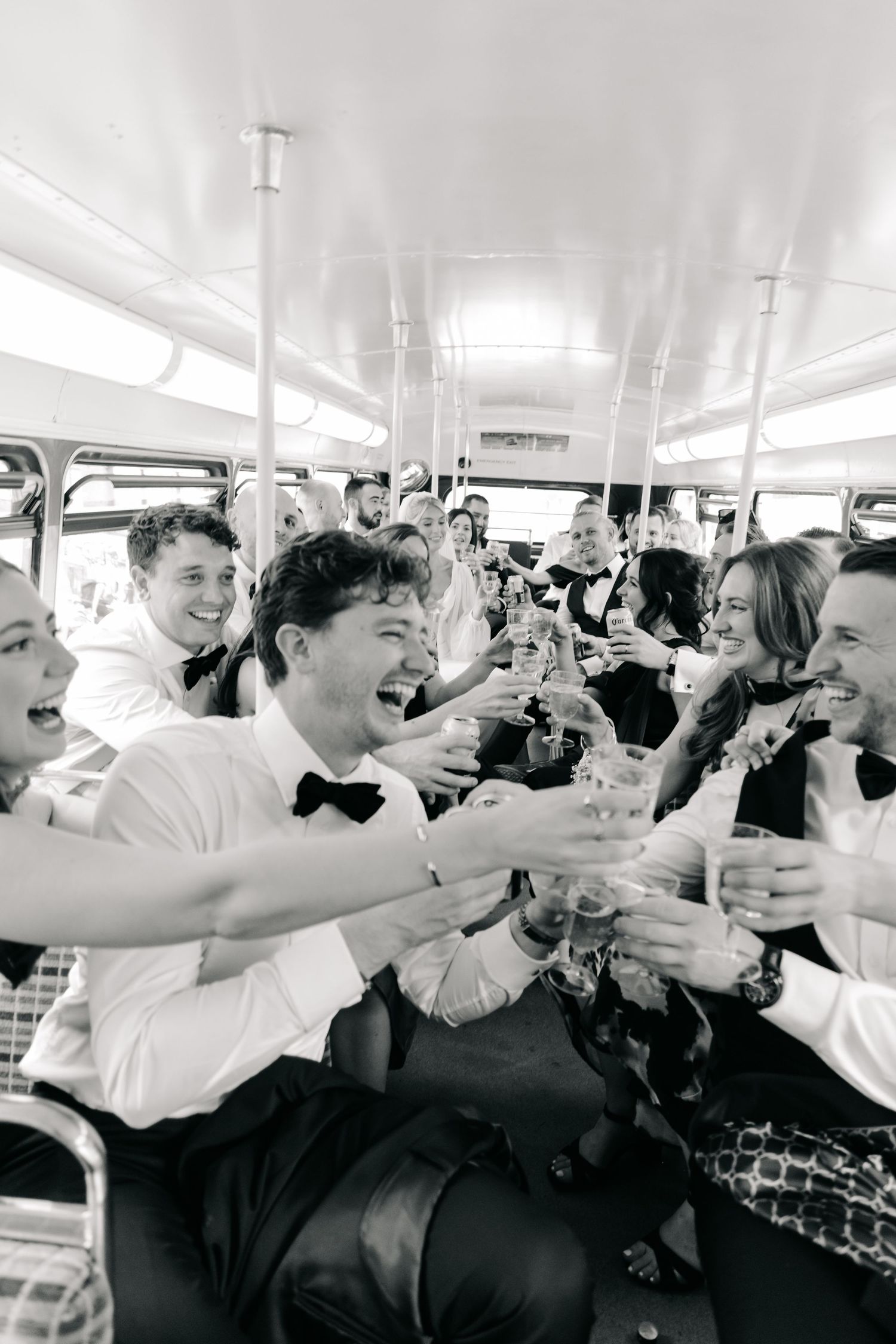 Wedding celebration on a boat with guests toasting and celebrating.