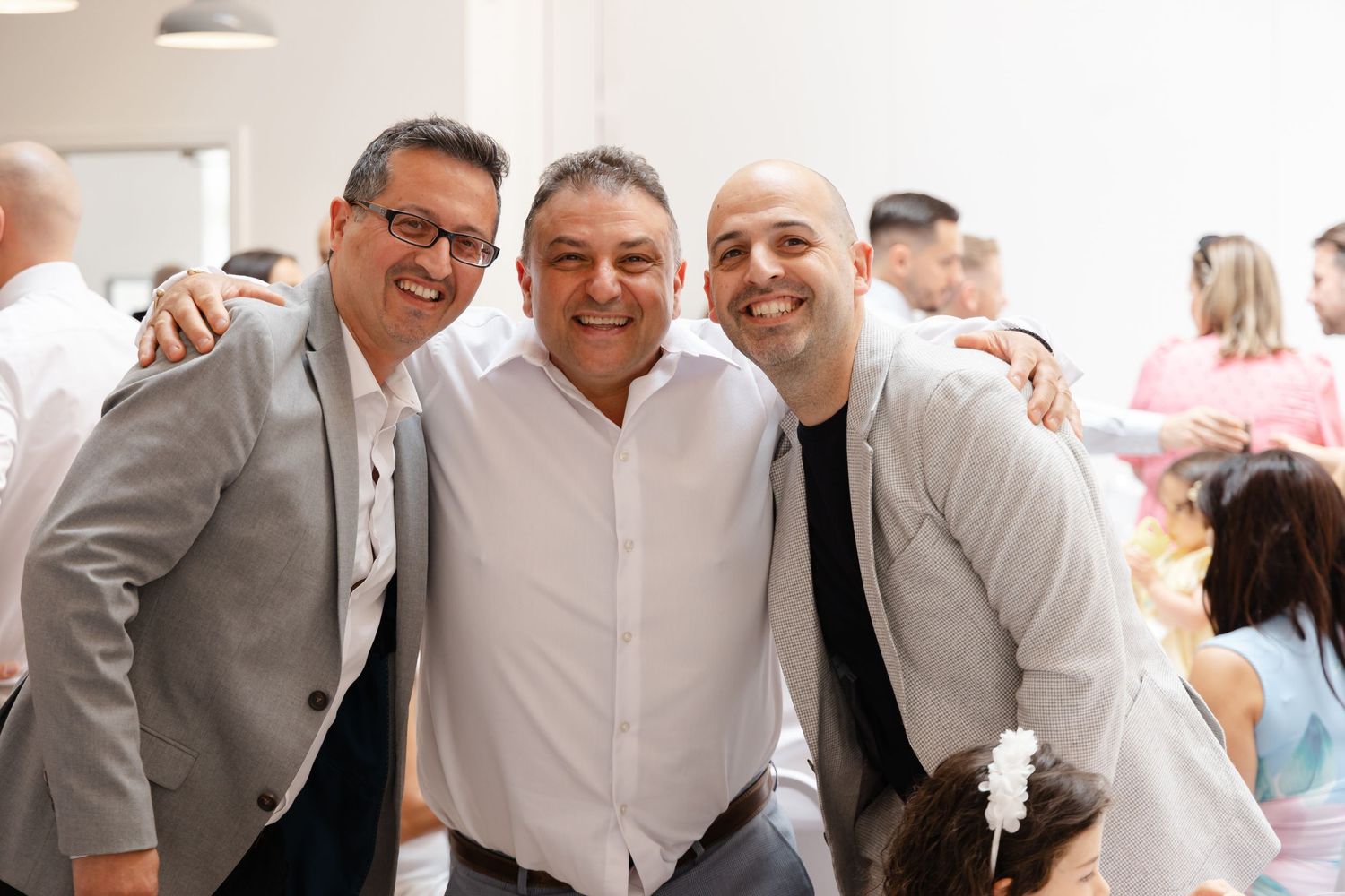 A group of guests celebrating and posing together at a formal event.