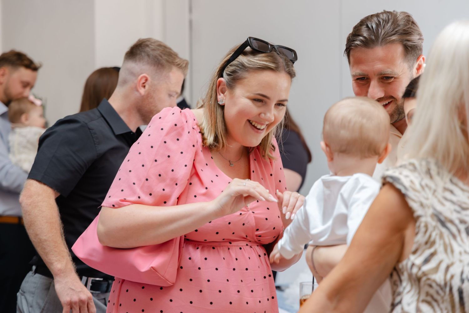 People dancing and embracing at a social gathering with joyful expressions.