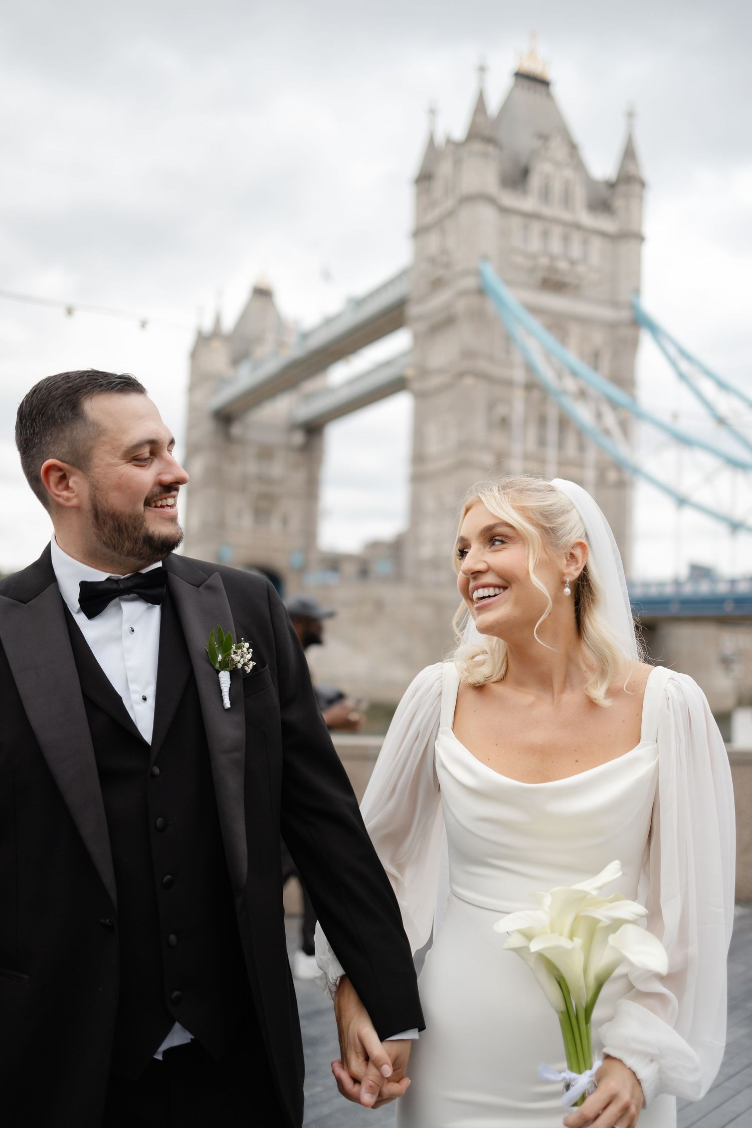 Romantic wedding portraits with Tower Bridge providing iconic London backdrop.