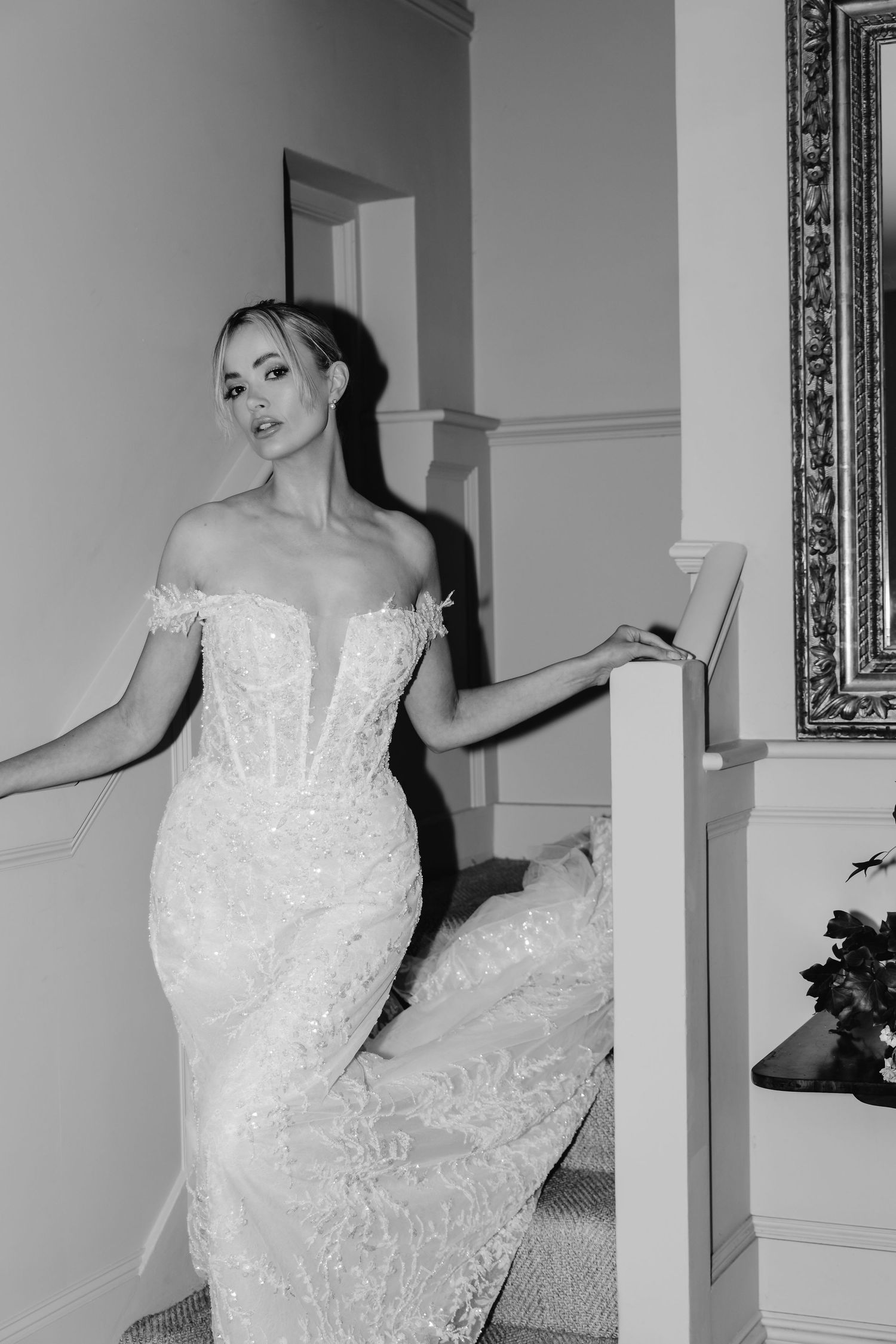 Artistic black and white series showing a bride posing dramatically in a white lace gown.