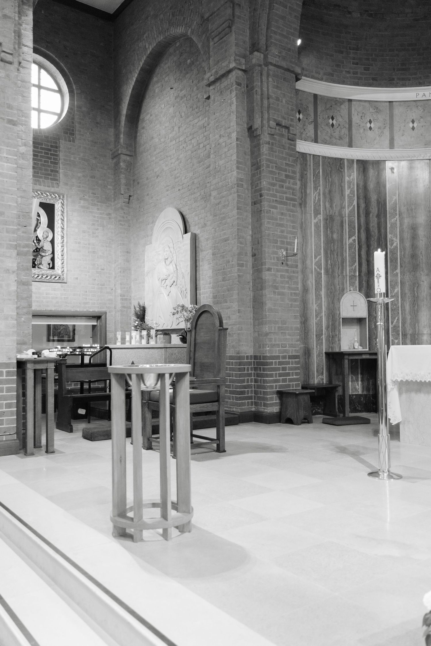 Black and white panorama of an empty church interior showing architectural details.