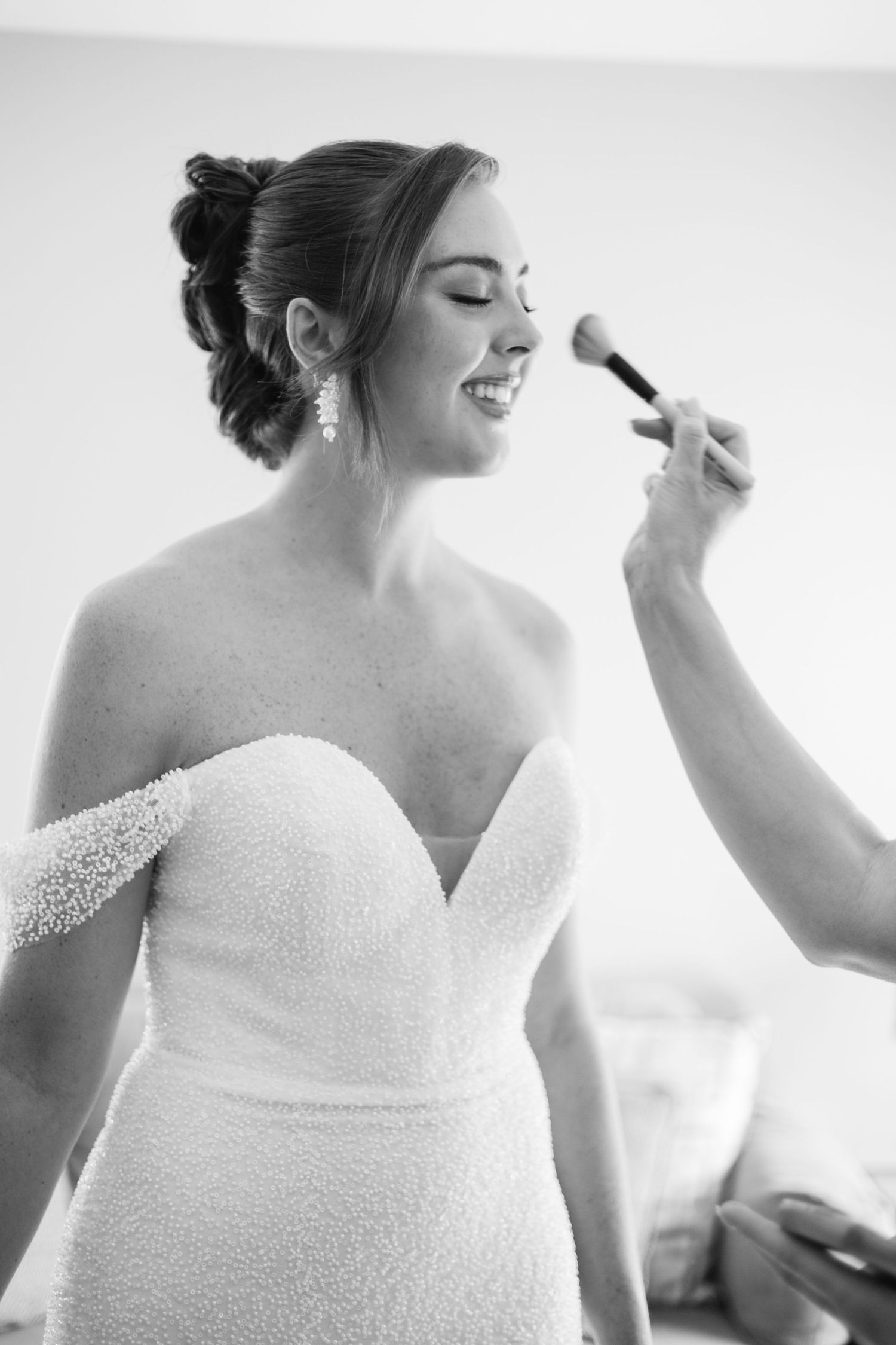 Close-up sequence of bride's beaded wedding dress bodice during preparation.